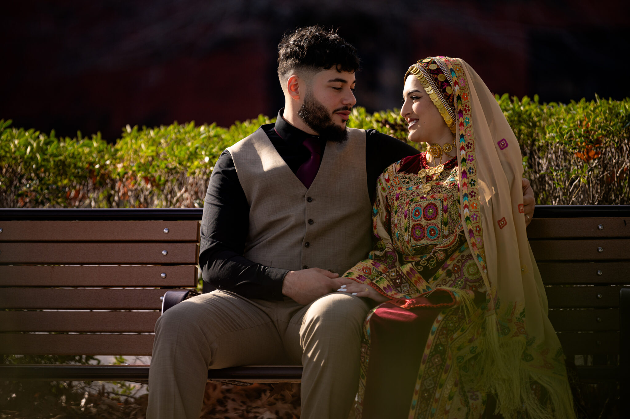 Bride & Groom sitting outside of Greenville Convention Center. Greenville, NC Wedding Photographer & Videographer.