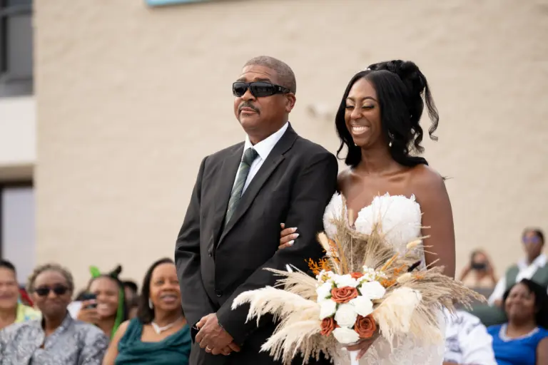 Why Wedding Videography Matters | True Essence Photography 1 Father in sunglasses walks the bride down the aisle