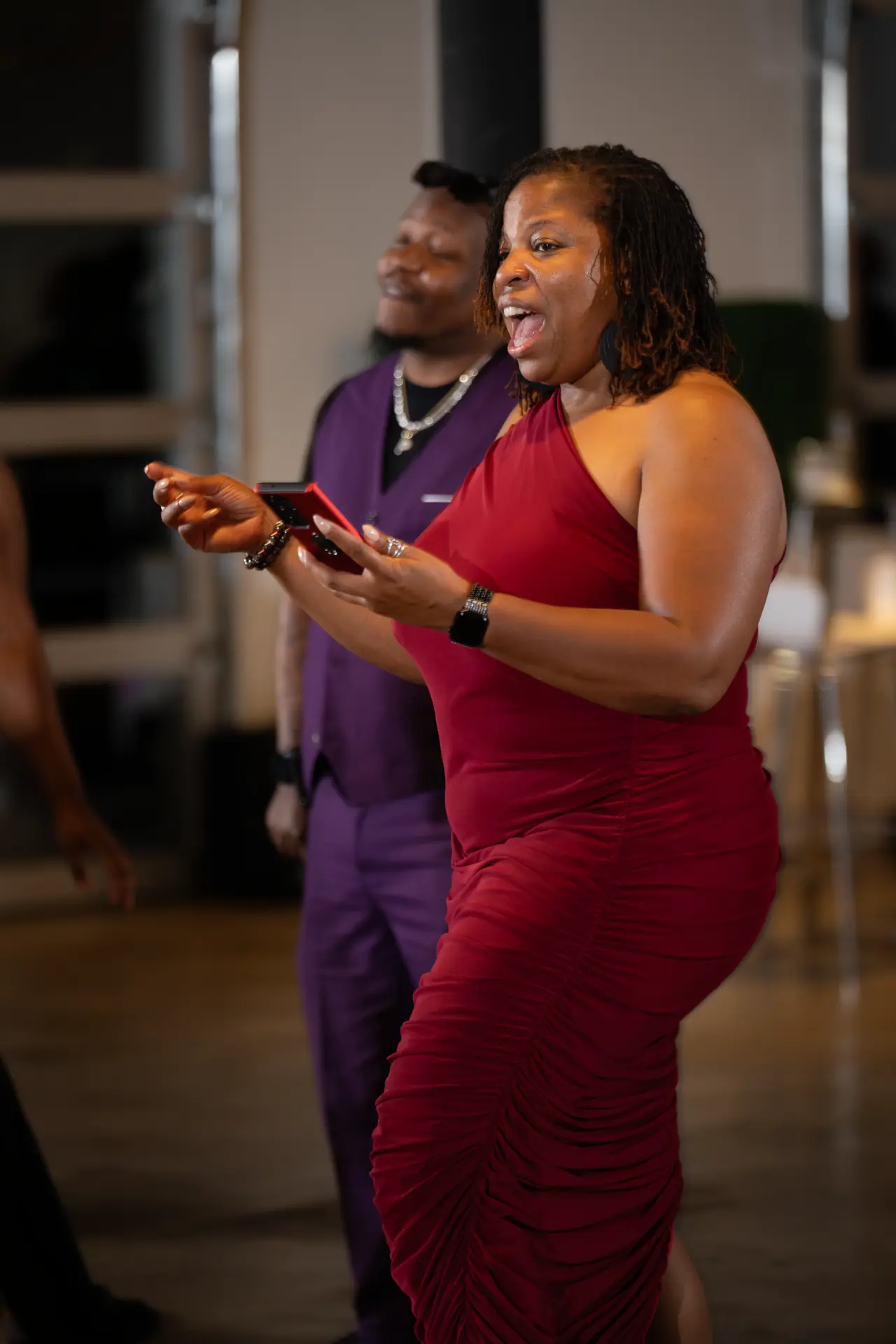 Woman in a red dress dancing at an evening event