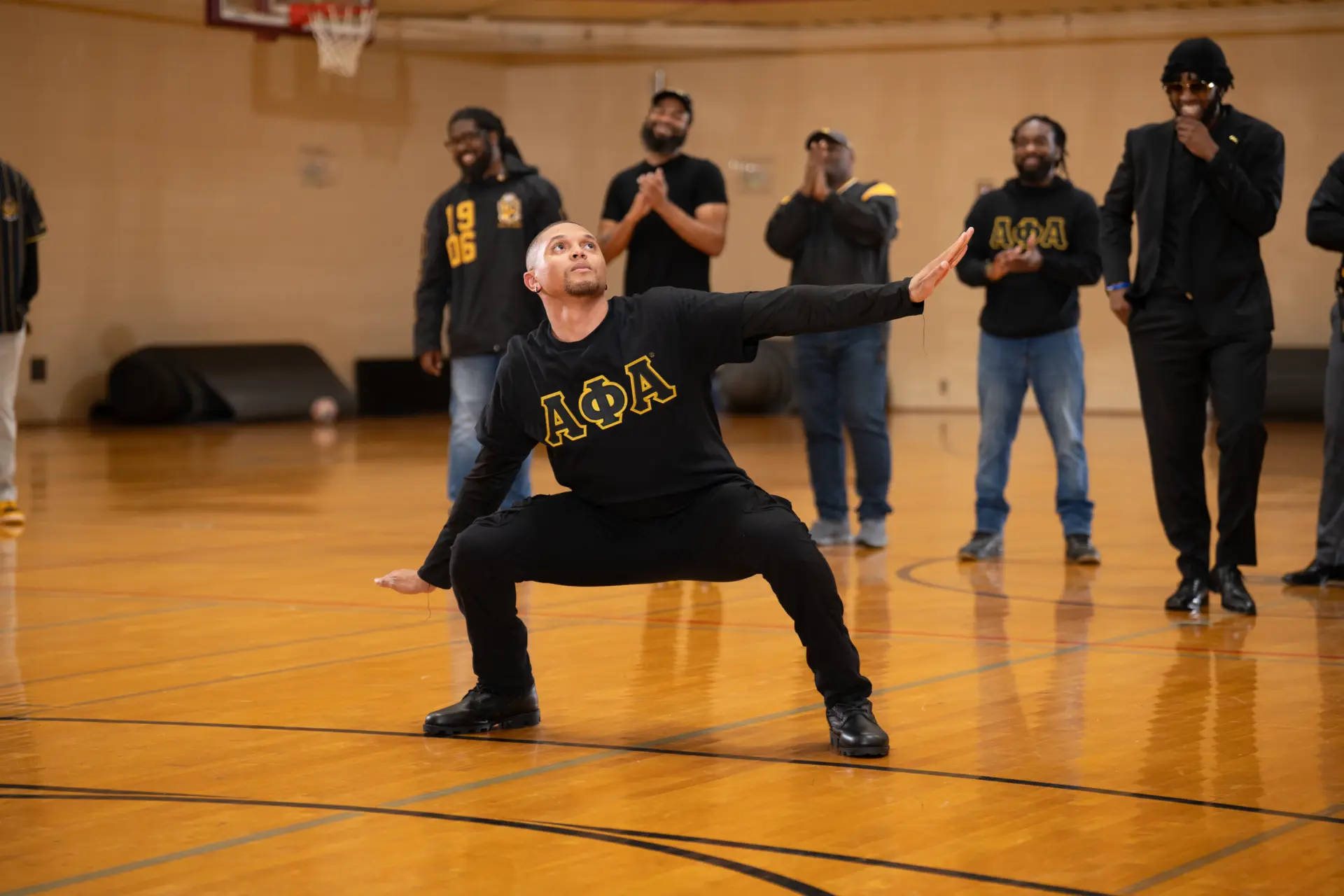 Fraternity members stepping in a gymnasium during a step show