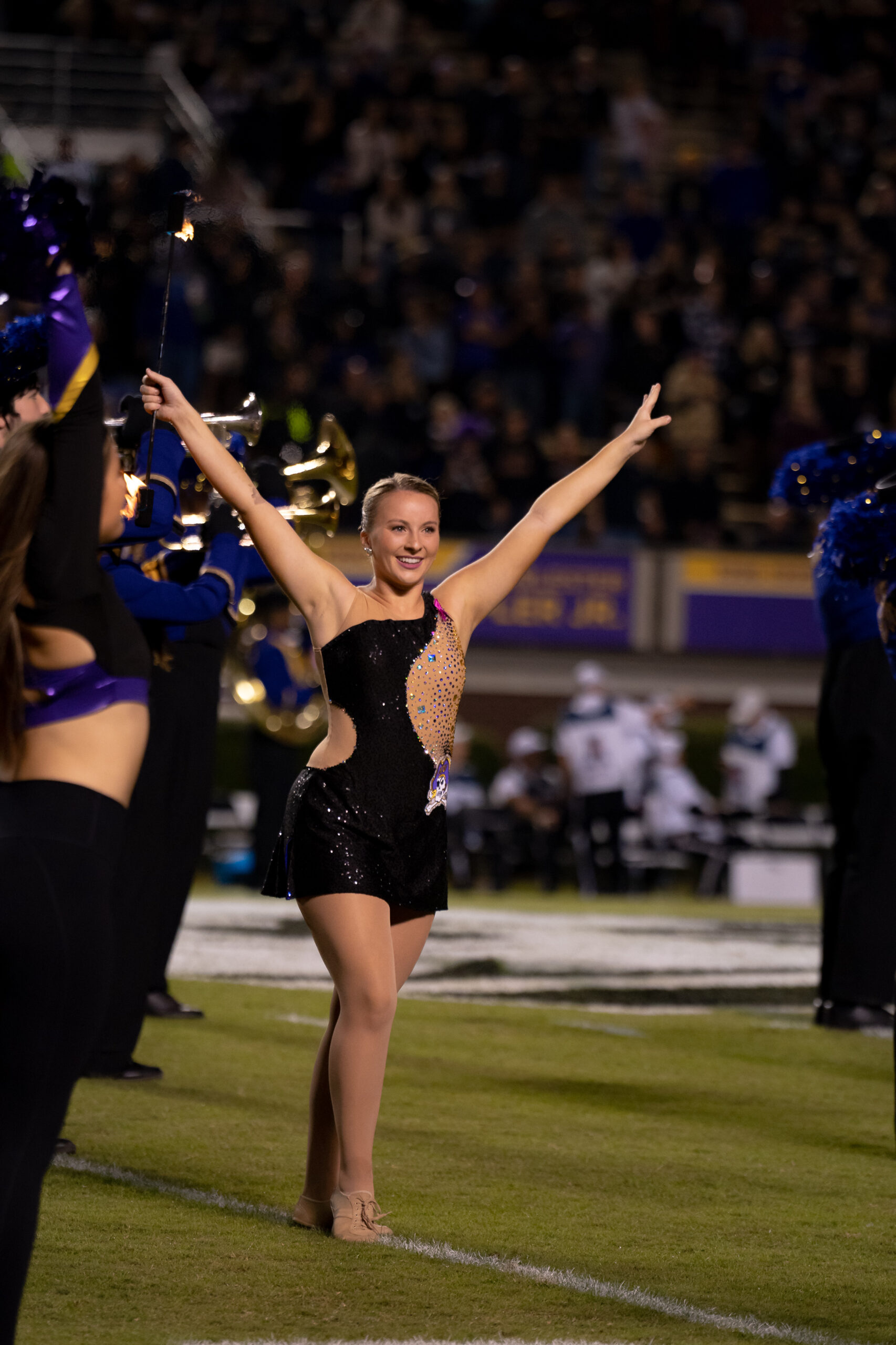 My First ECU College Football Photography Assignment 290 ECU dancer performing with arms raised on the field