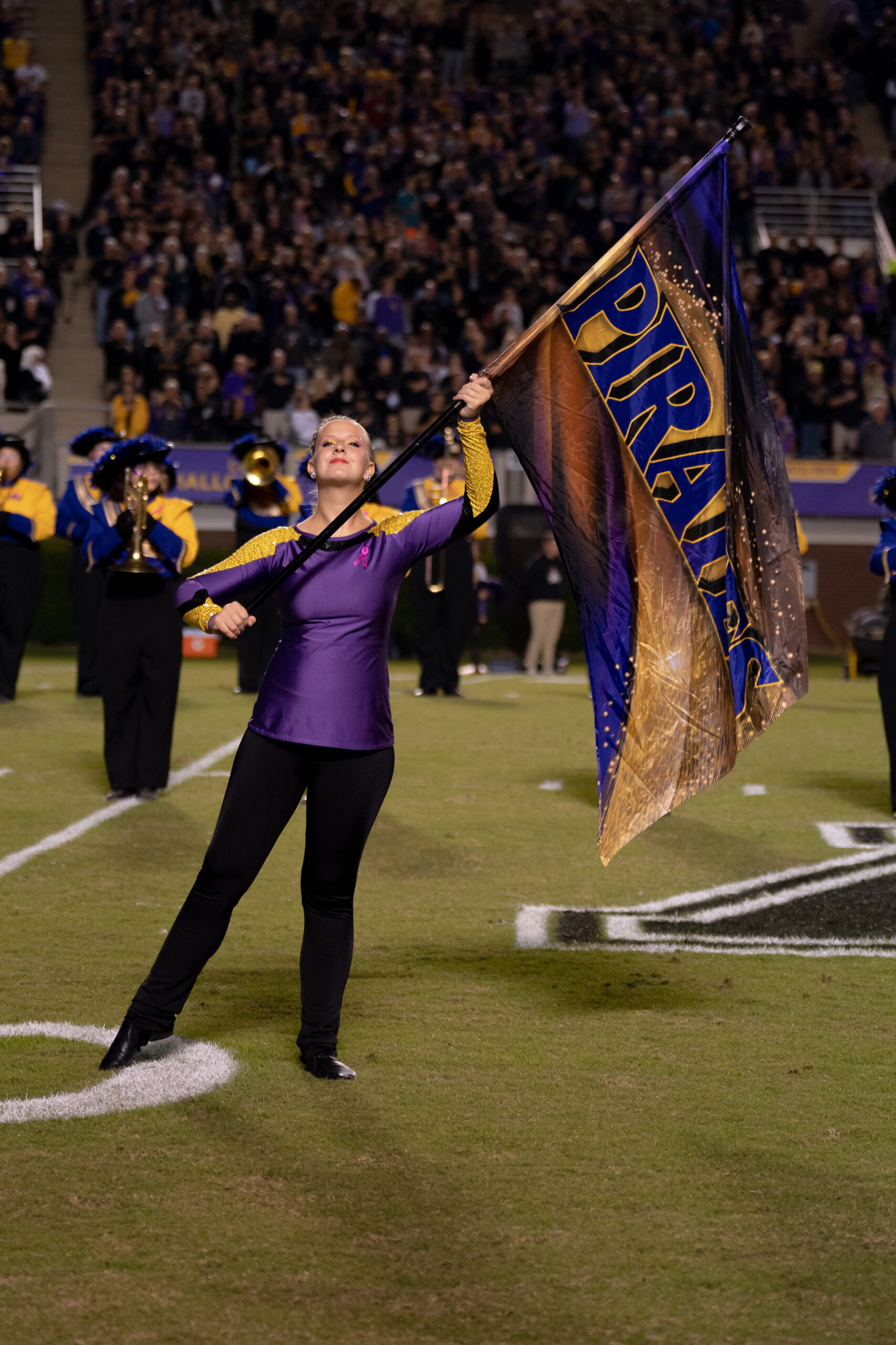 My First ECU College Football Photography Assignment 233 ECU color guard member waving a flag on the field