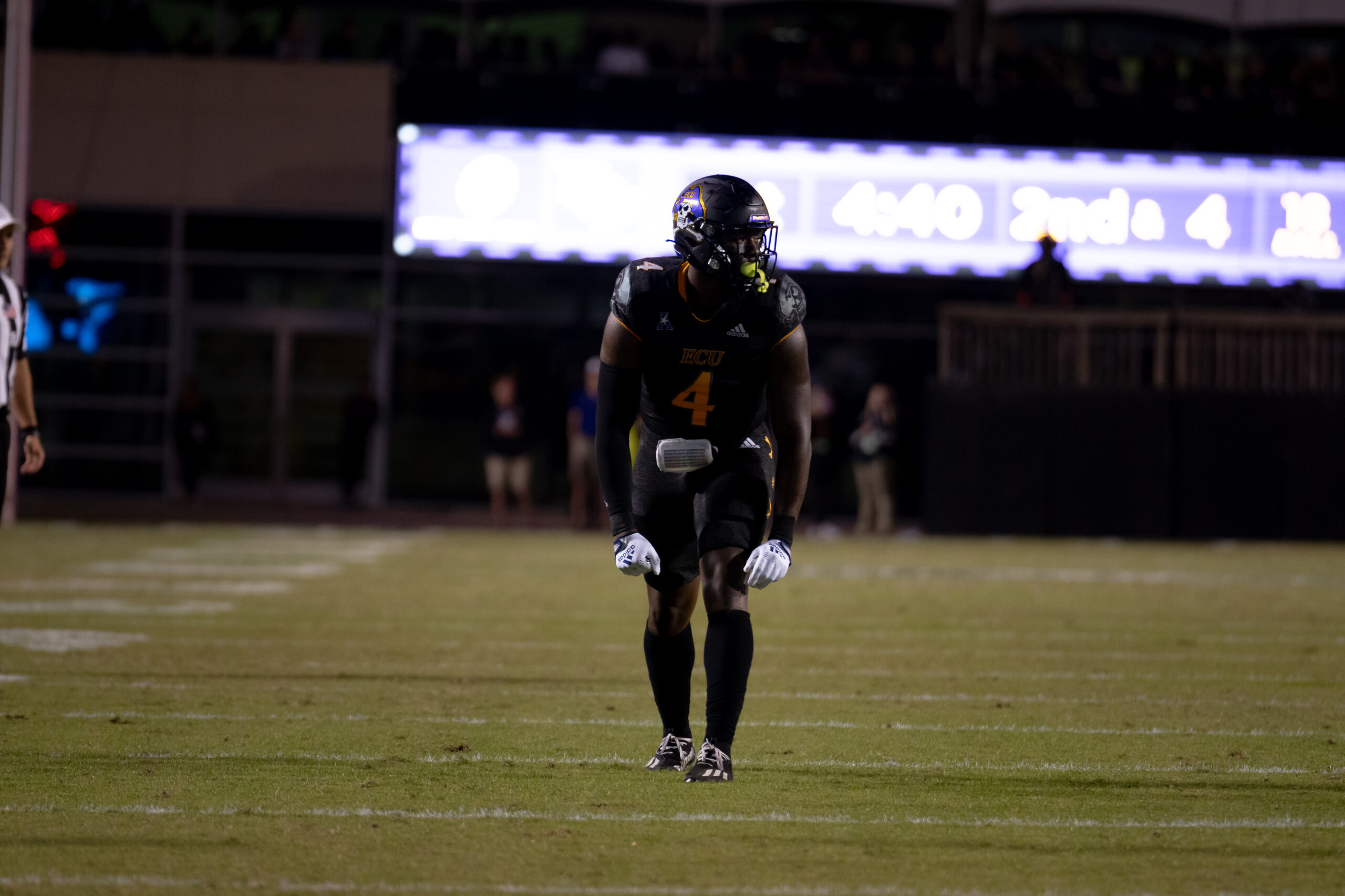 My First ECU College Football Photography Assignment 114 Lone ECU player walking under the scoreboard lights