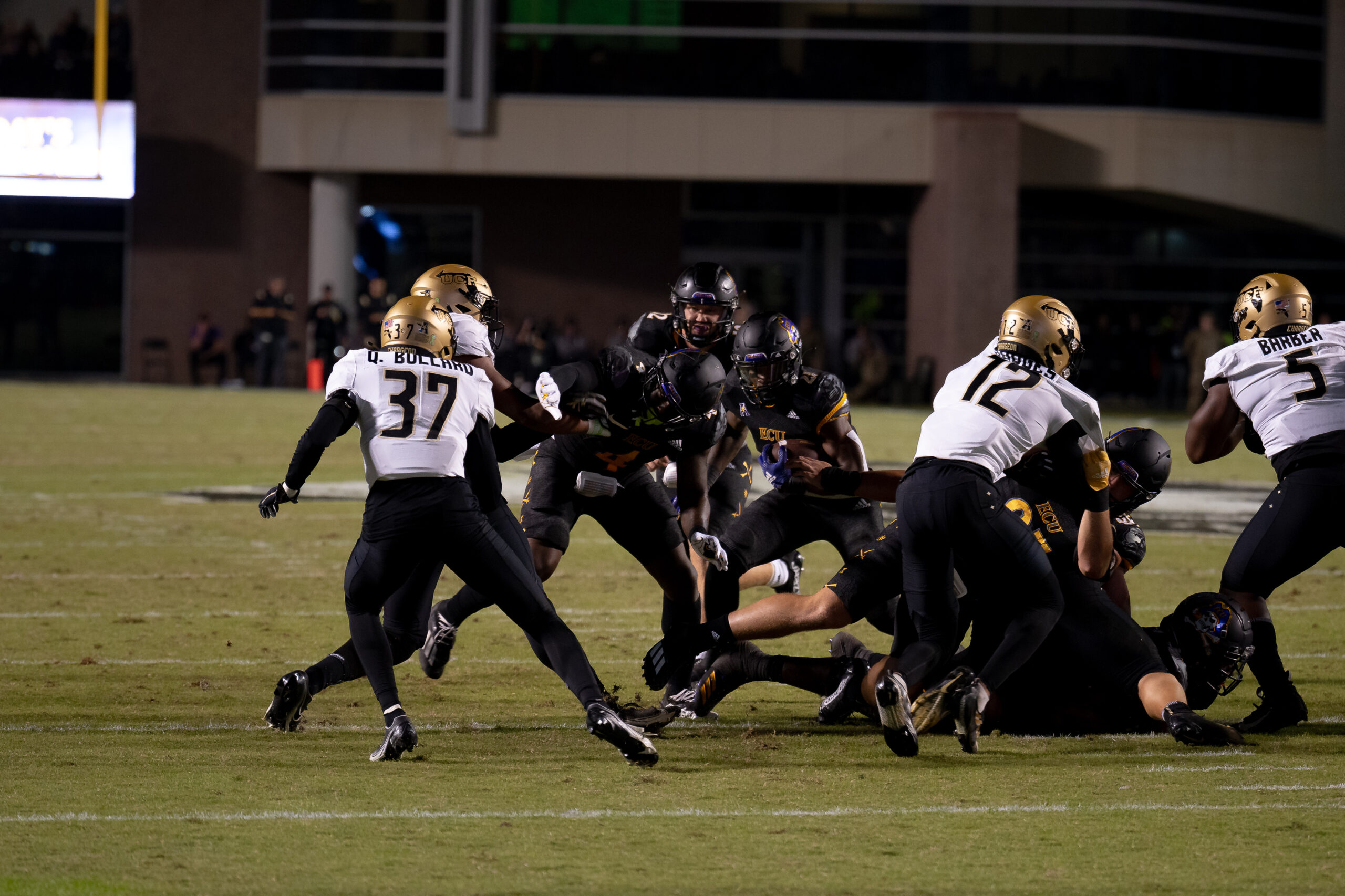 My First ECU College Football Photography Assignment 120 ECU defenders bringing down a UCF ball carrier