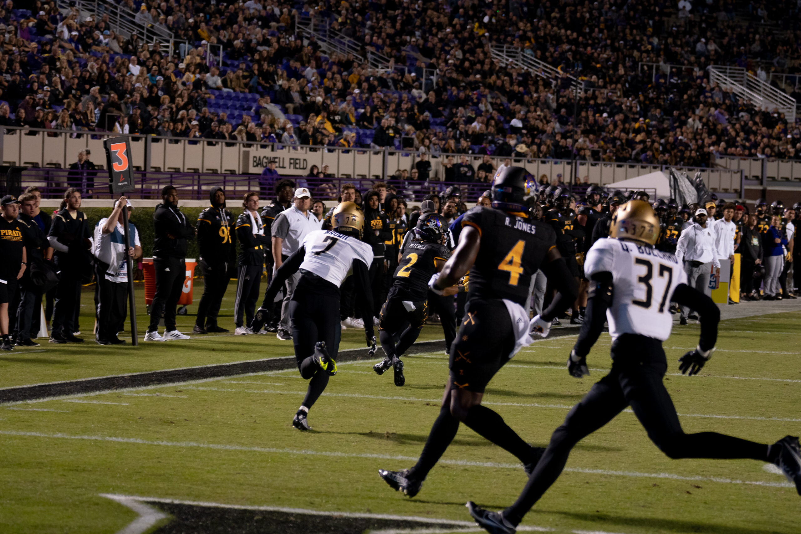 My First ECU College Football Photography Assignment 199 Runner breaking through the line with defenders trailing