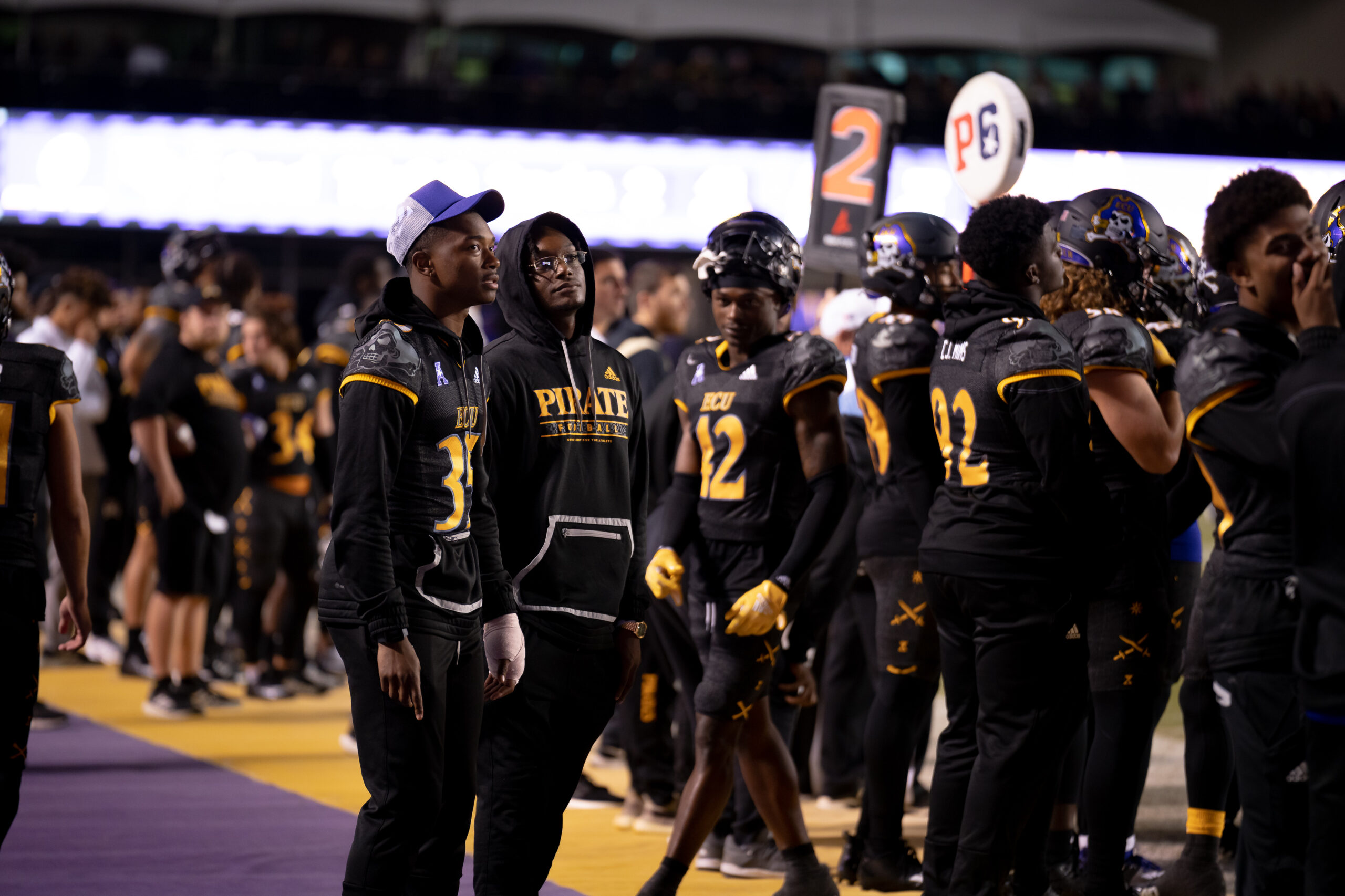 My First ECU College Football Photography Assignment 66 ECU players celebrating with a raised trophy on the sideline