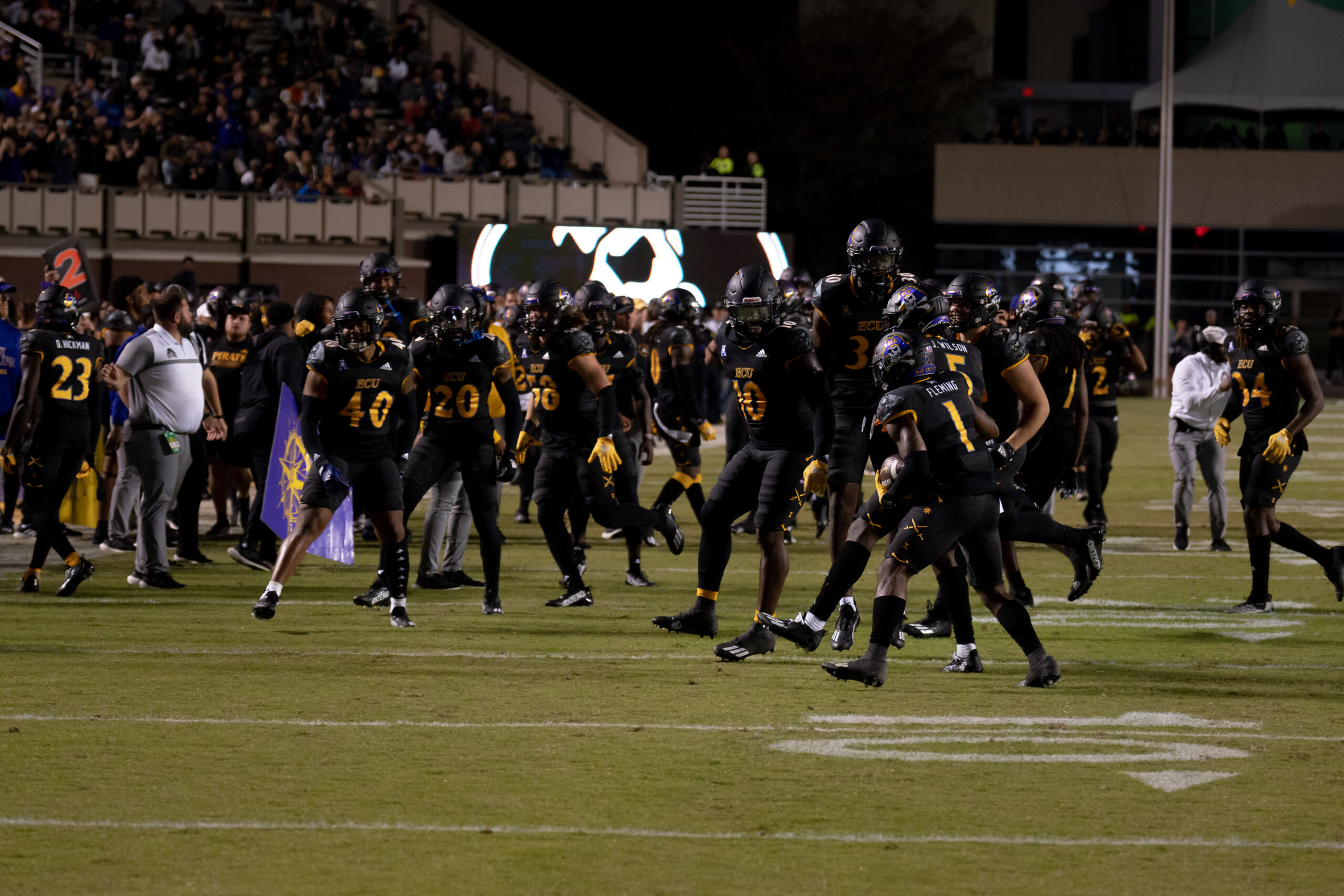 My First ECU College Football Photography Assignment 21 ECU players celebrating together on the field