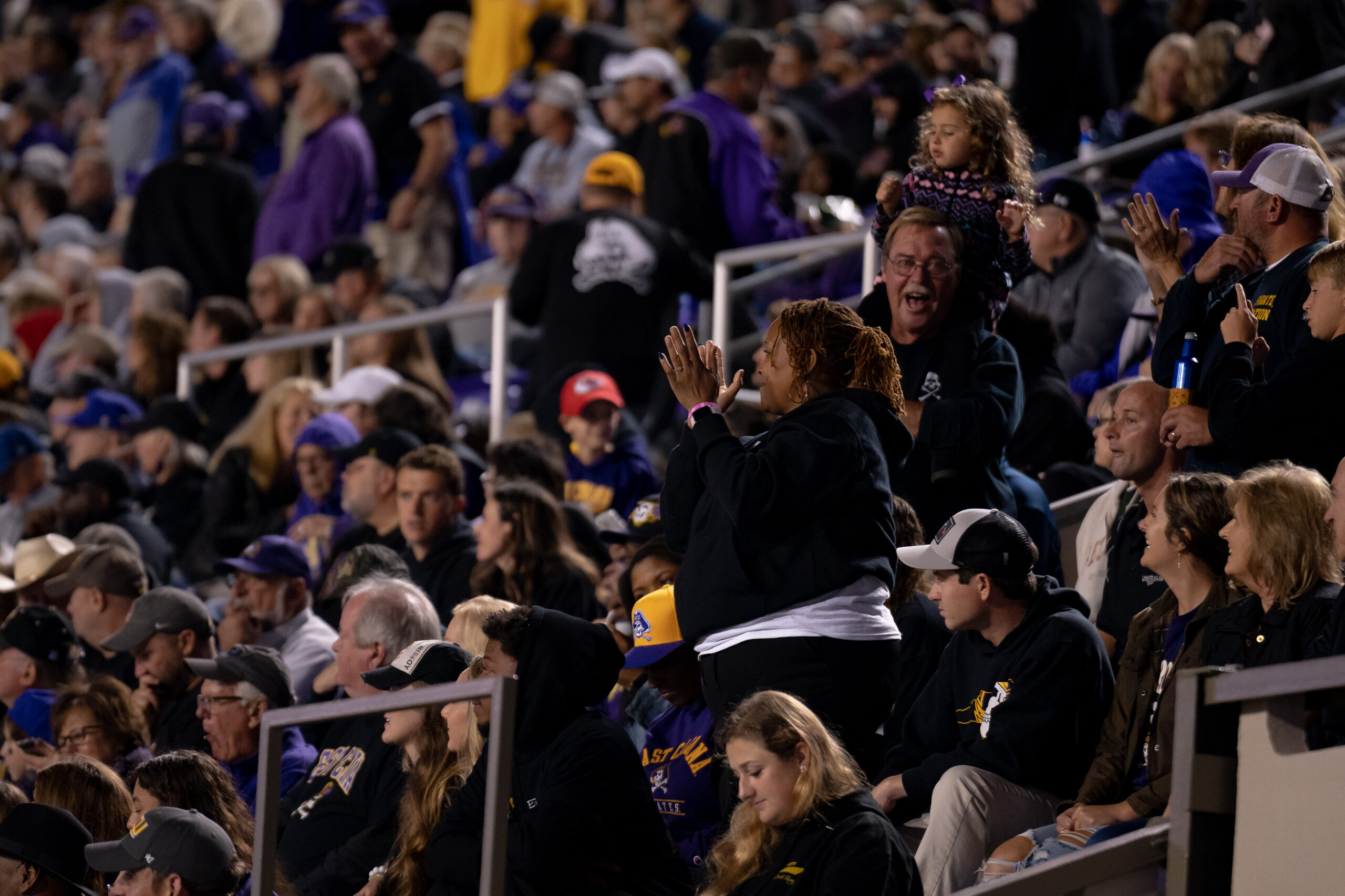 My First ECU College Football Photography Assignment 121 ECU fans in purple cheering in the stands