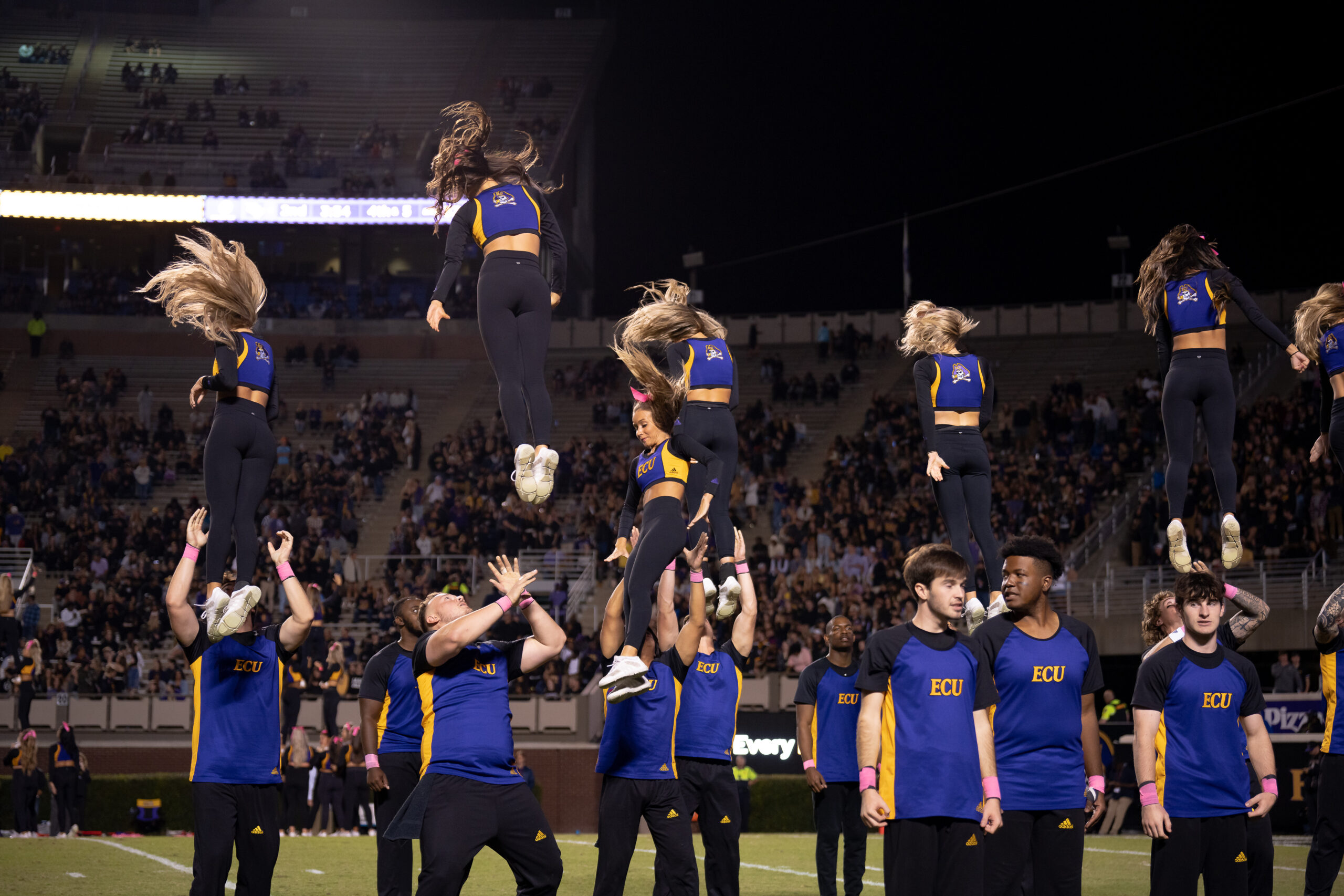 My First ECU College Football Photography Assignment 253 ECU cheerleaders building a stunt in front of fans