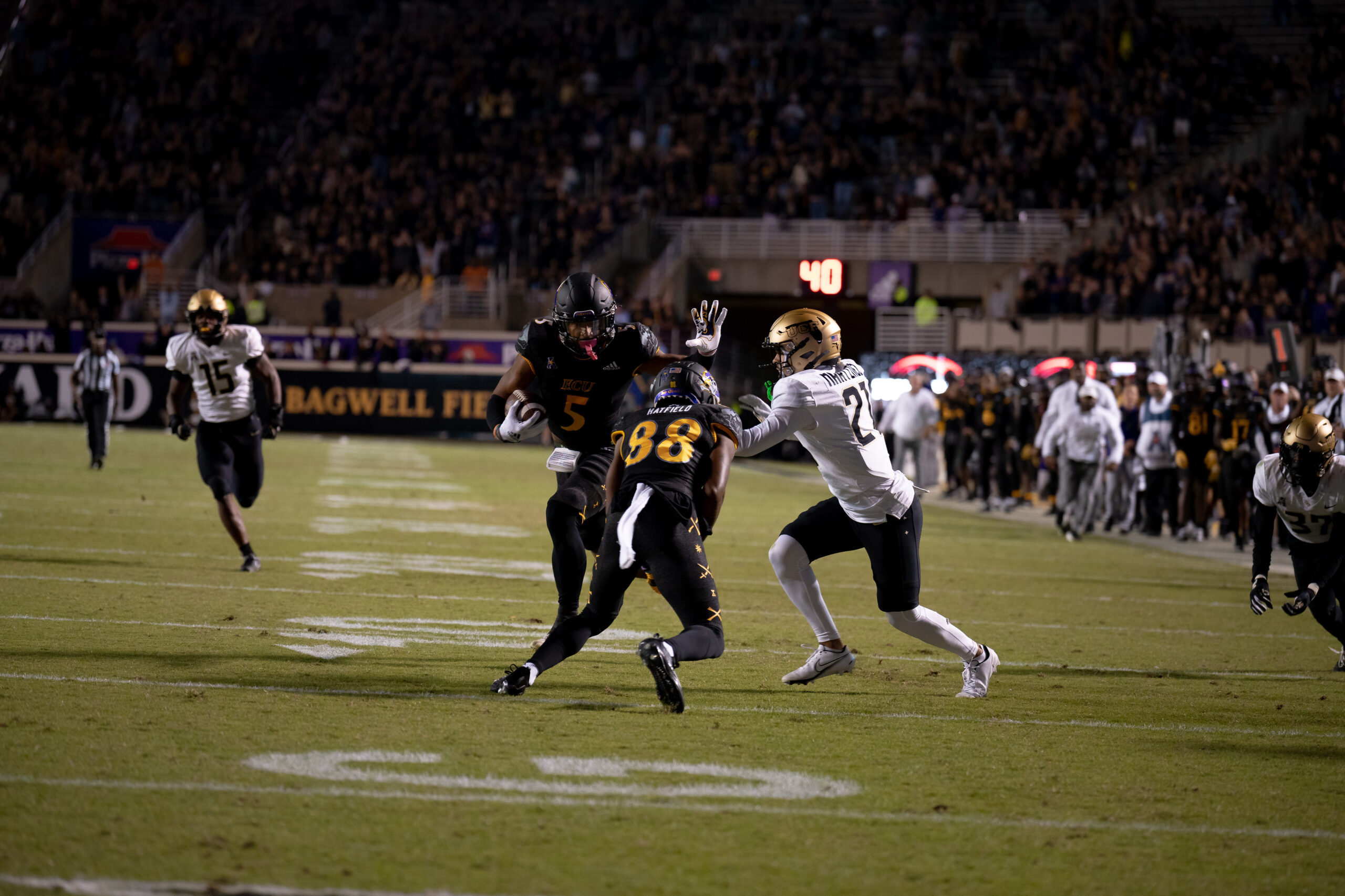 My First ECU College Football Photography Assignment 190 Ball carrier breaking a tackle near midfield