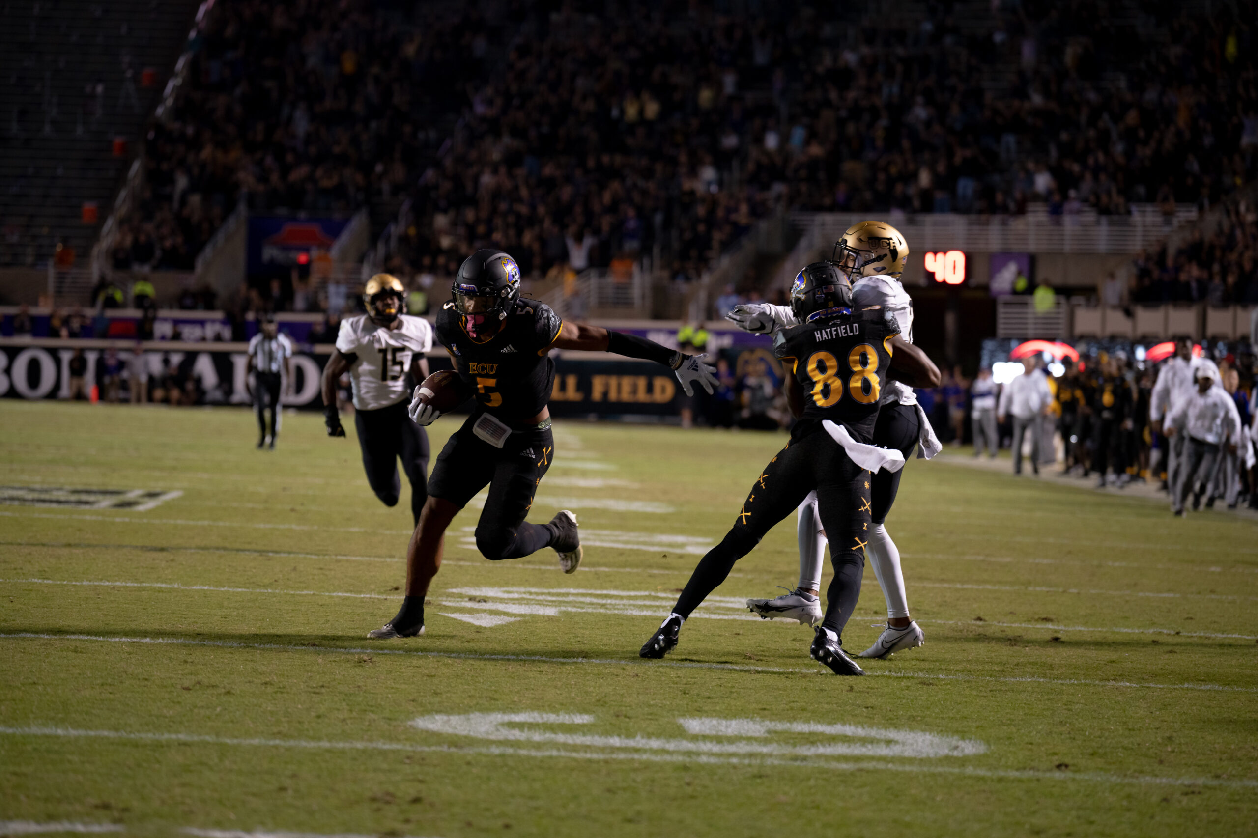 My First ECU College Football Photography Assignment 102 Runner cutting upfield past a defender
