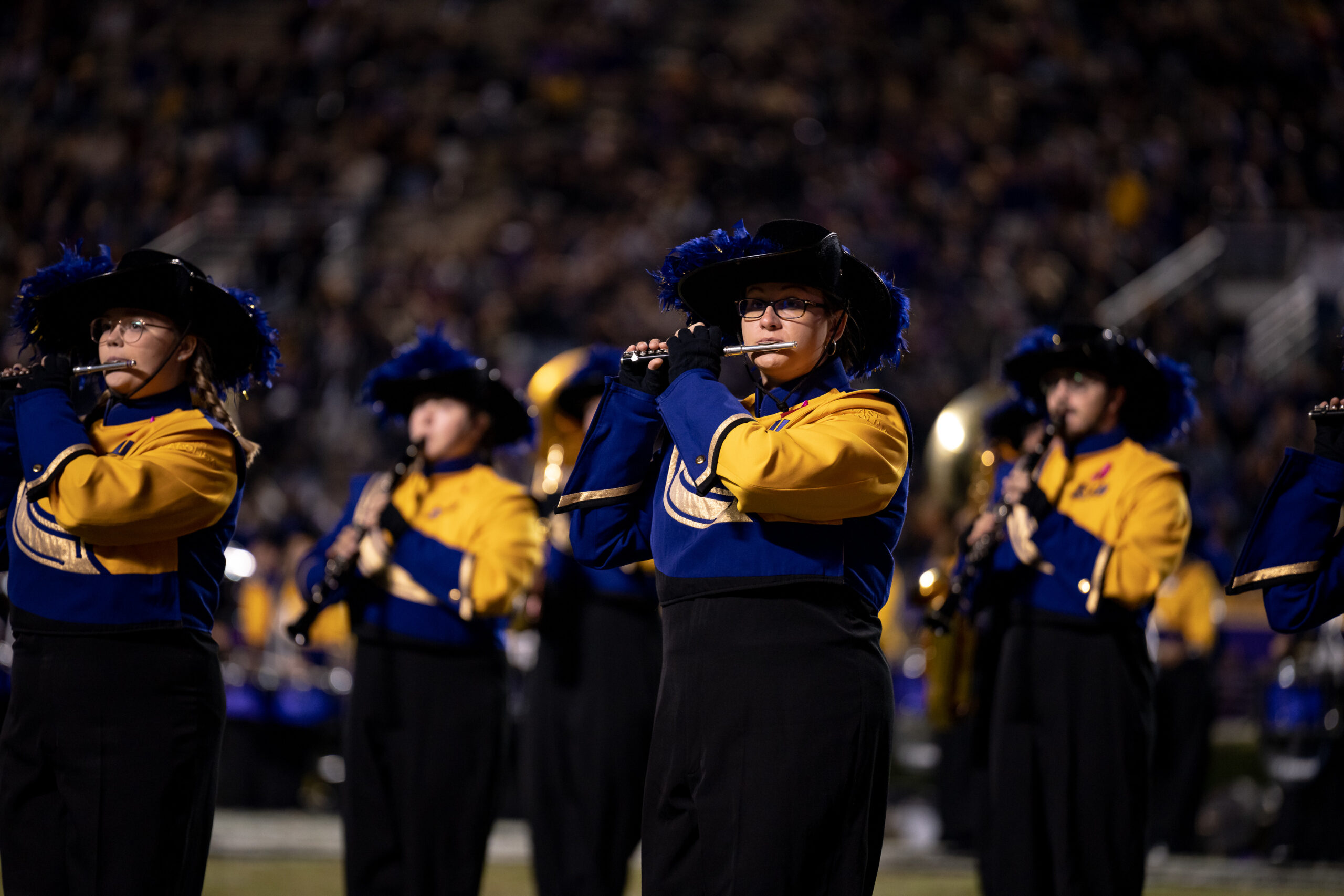 My First ECU College Football Photography Assignment 12 ECU marching band members in plumed hats playing in the stands