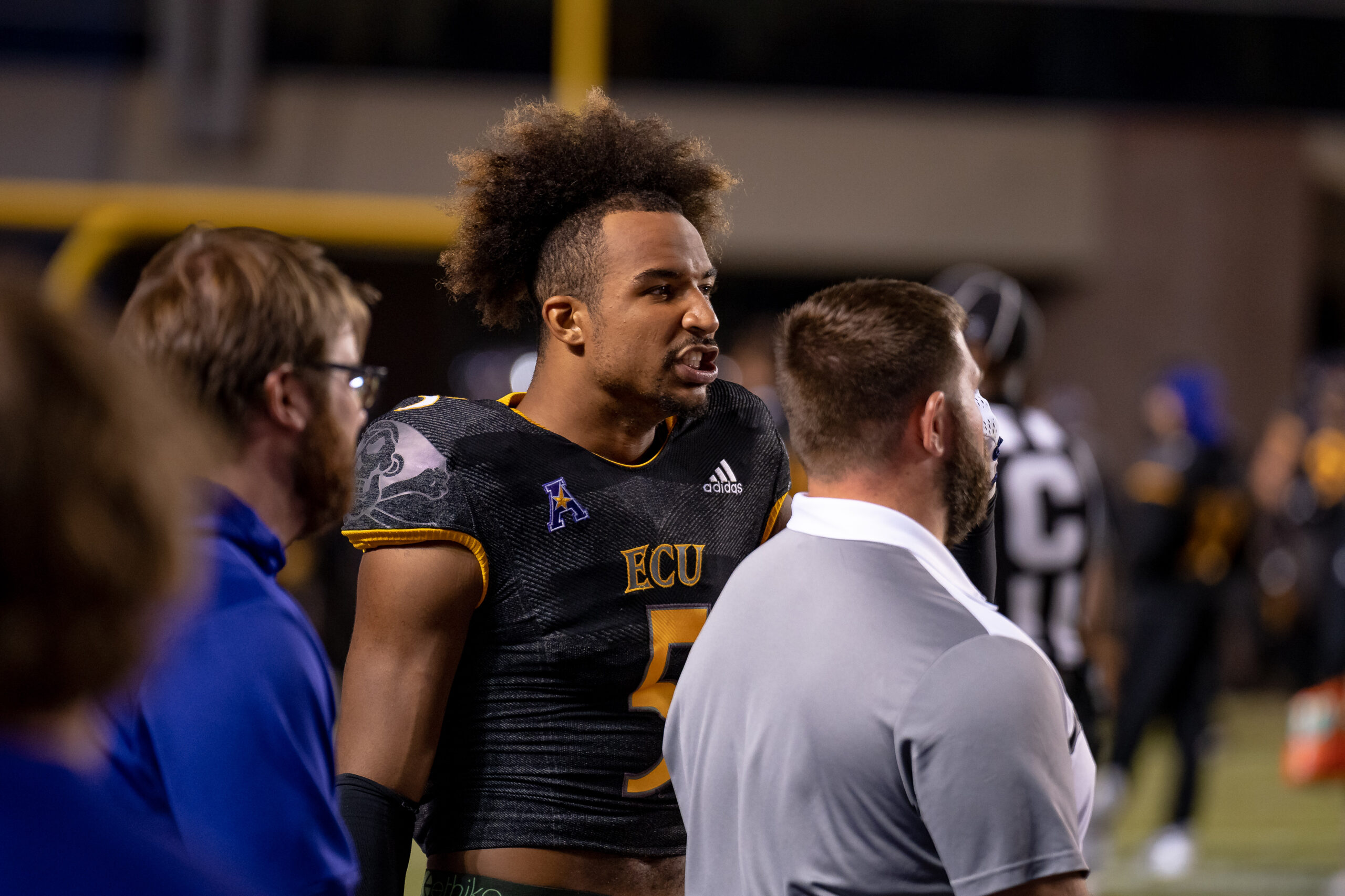 My First ECU College Football Photography Assignment 175 ECU player smiling on the sideline near fans