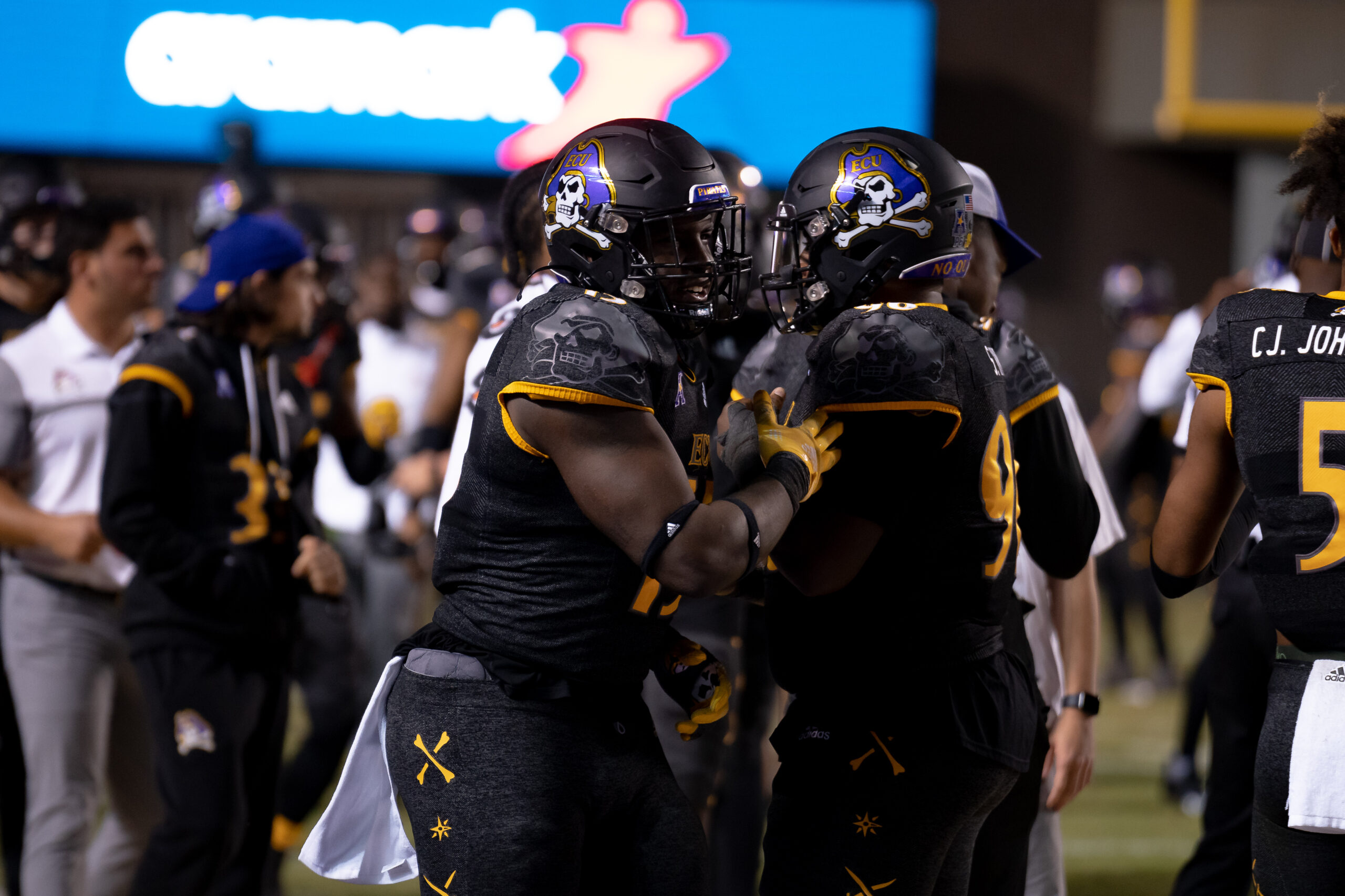 My First ECU College Football Photography Assignment 99 ECU players in helmets gathered on the sideline