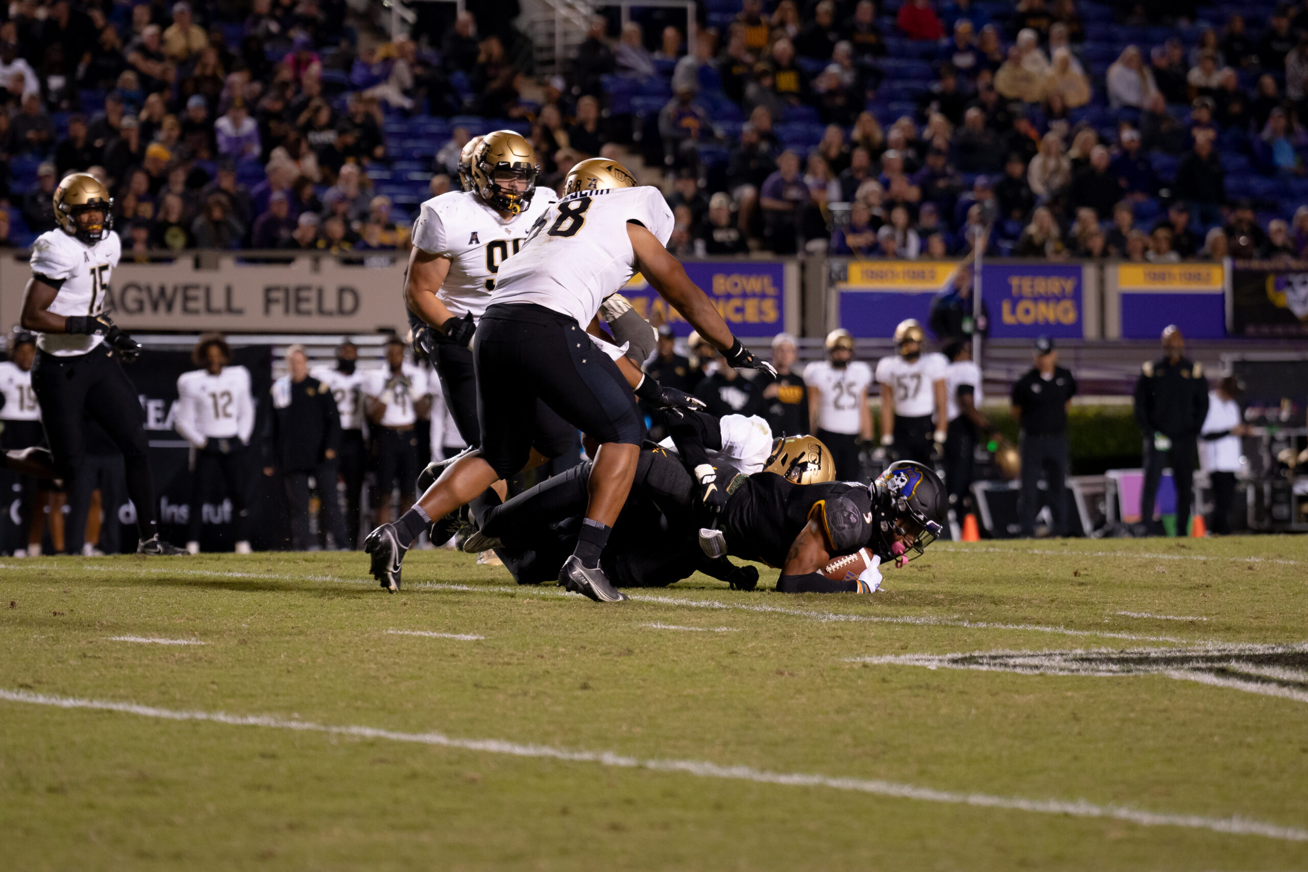 My First ECU College Football Photography Assignment 112 Players tangled in a tackle near the sideline