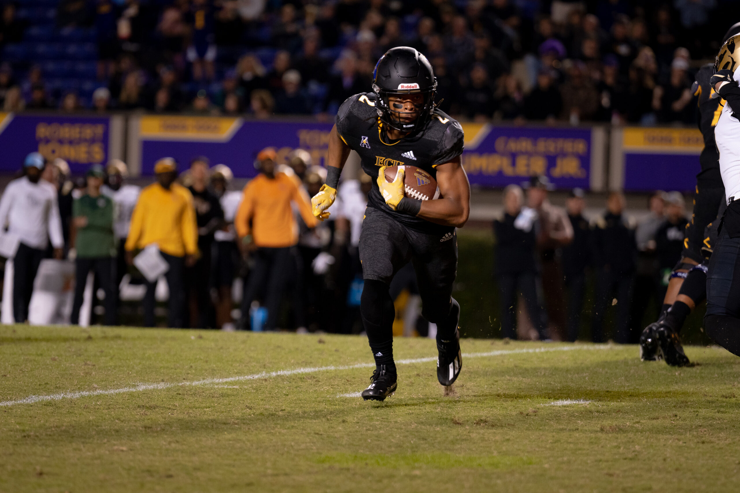 My First ECU College Football Photography Assignment 76 ECU player in black jogging across the field