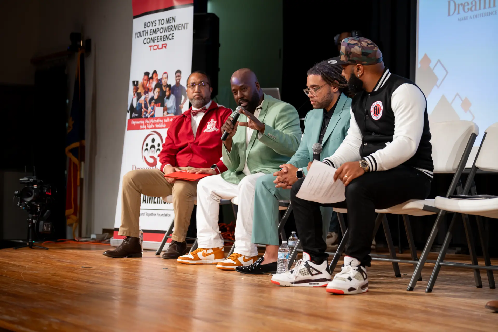 Panelists seated on stage during a community event