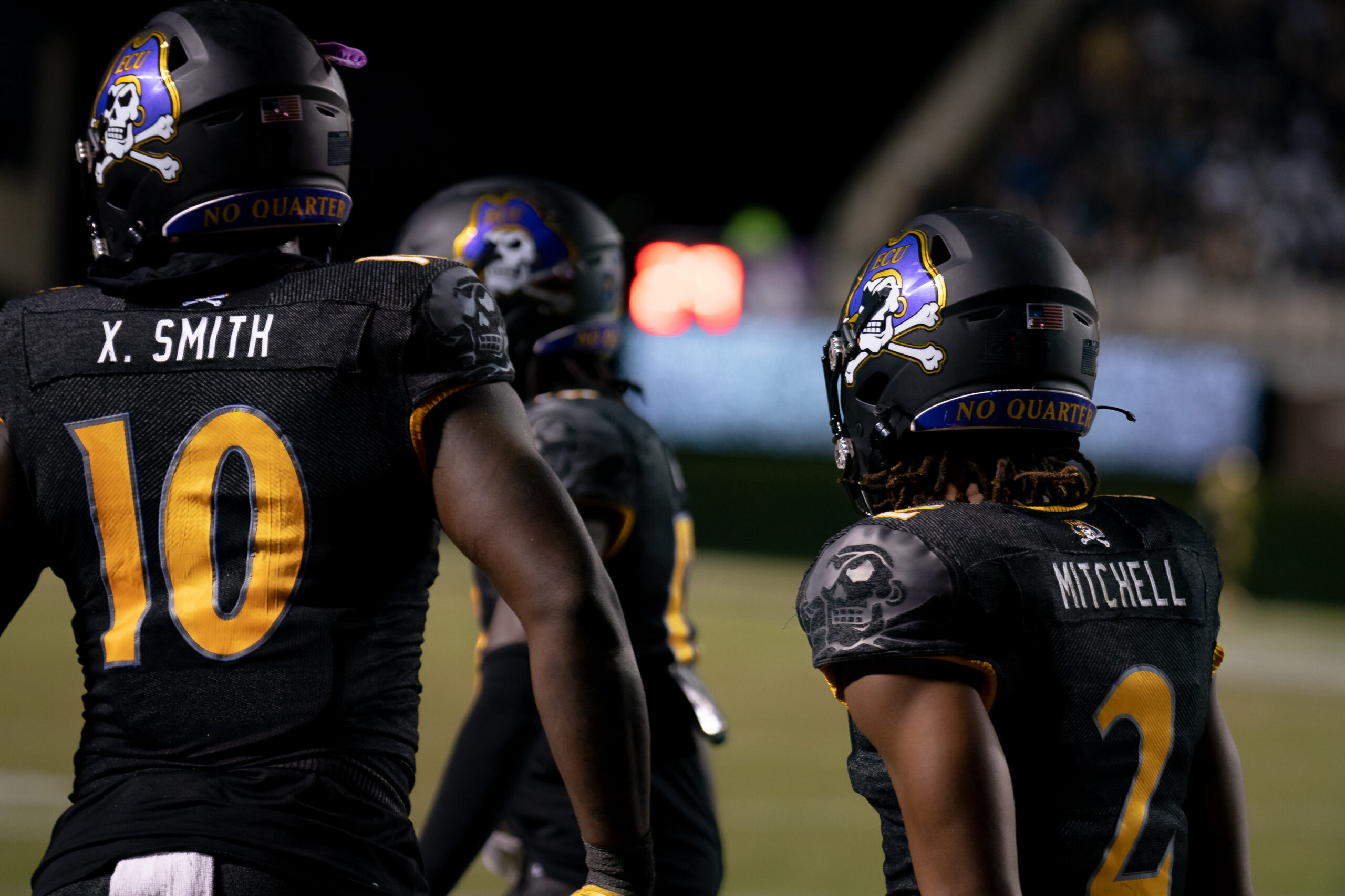 My First ECU College Football Photography Assignment 294 ECU players No. 10 and No. 21 on the sideline in black uniforms