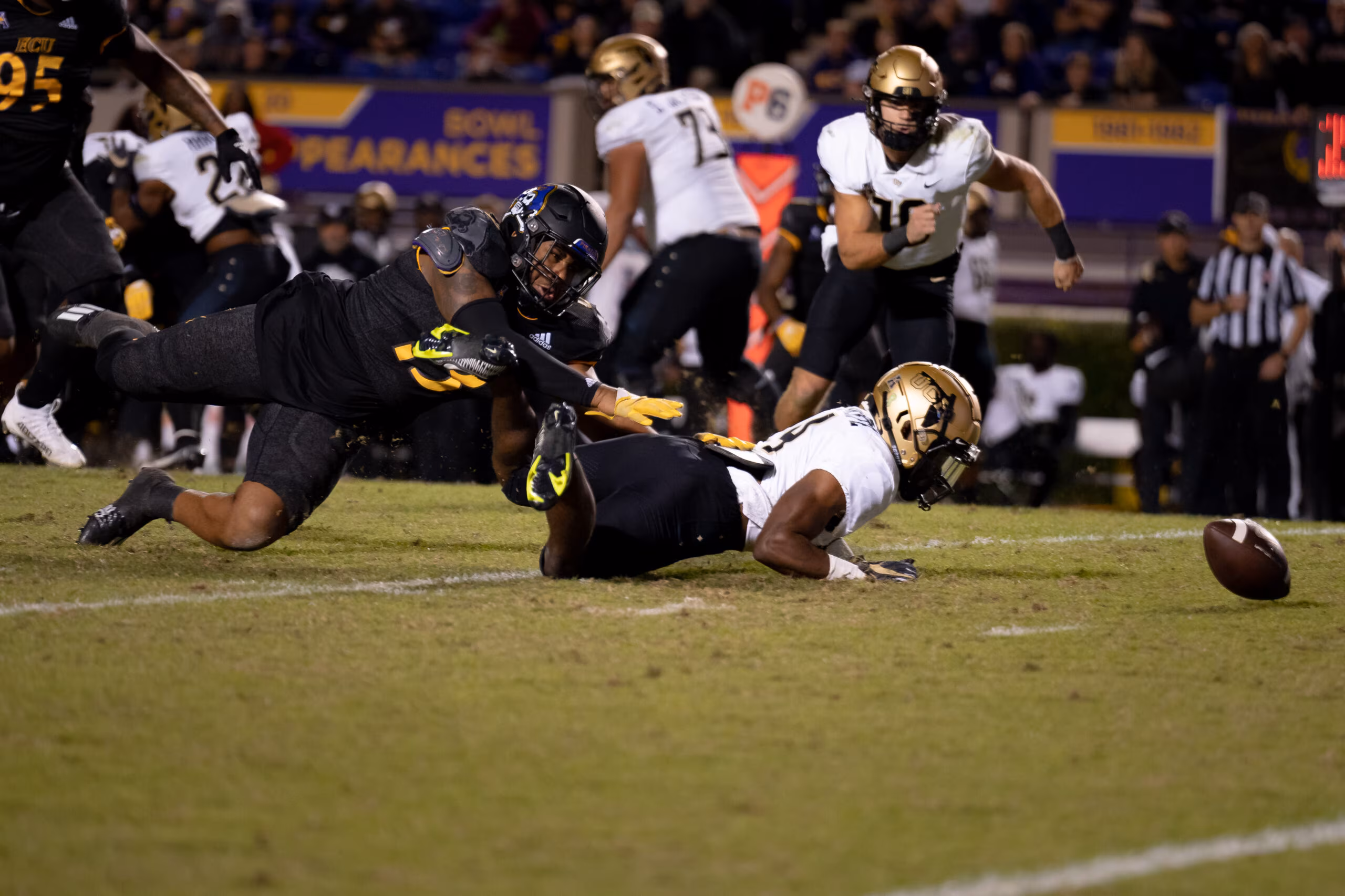 My First ECU College Football Photography Assignment 92 Players piling on a loose ball in front of the stands