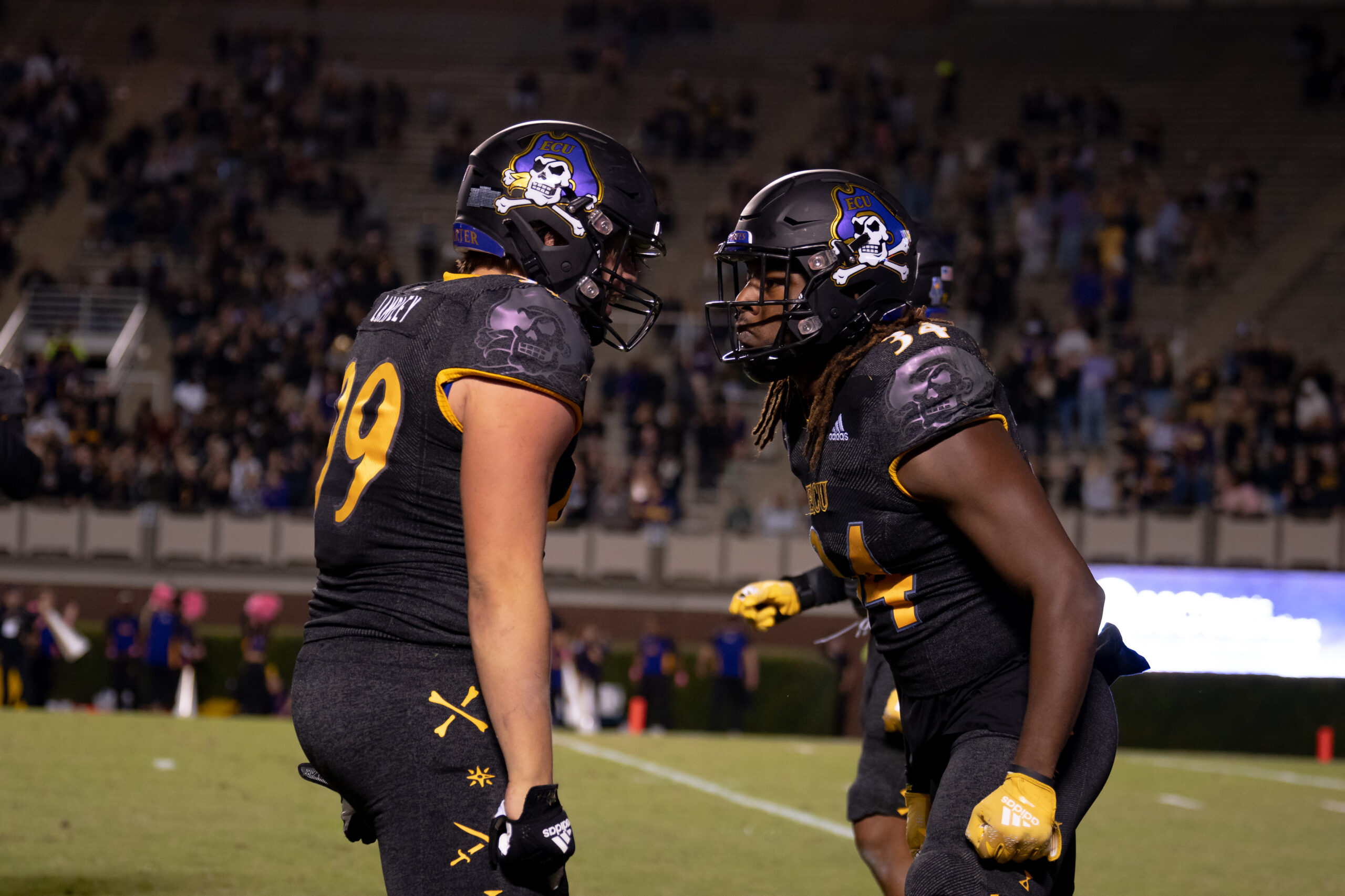 My First ECU College Football Photography Assignment 15 ECU players in black jerseys walking along the sideline