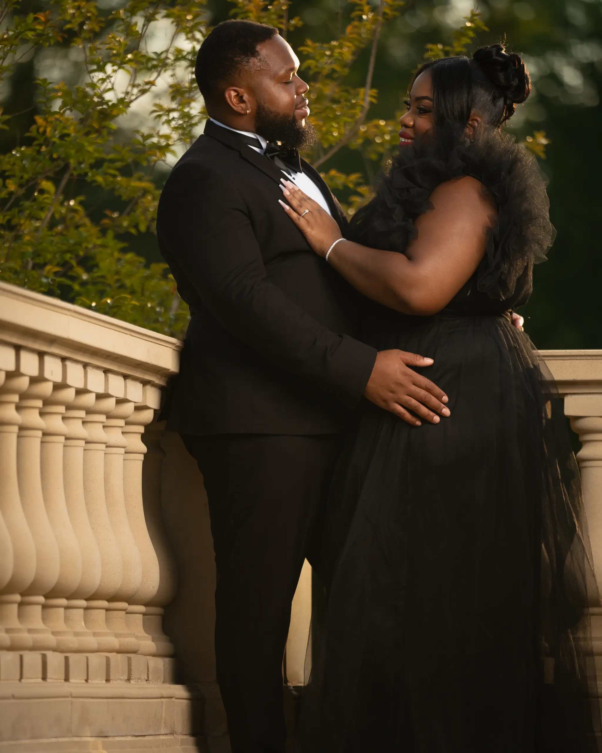 Couple holds each other on an elegant stone terrace