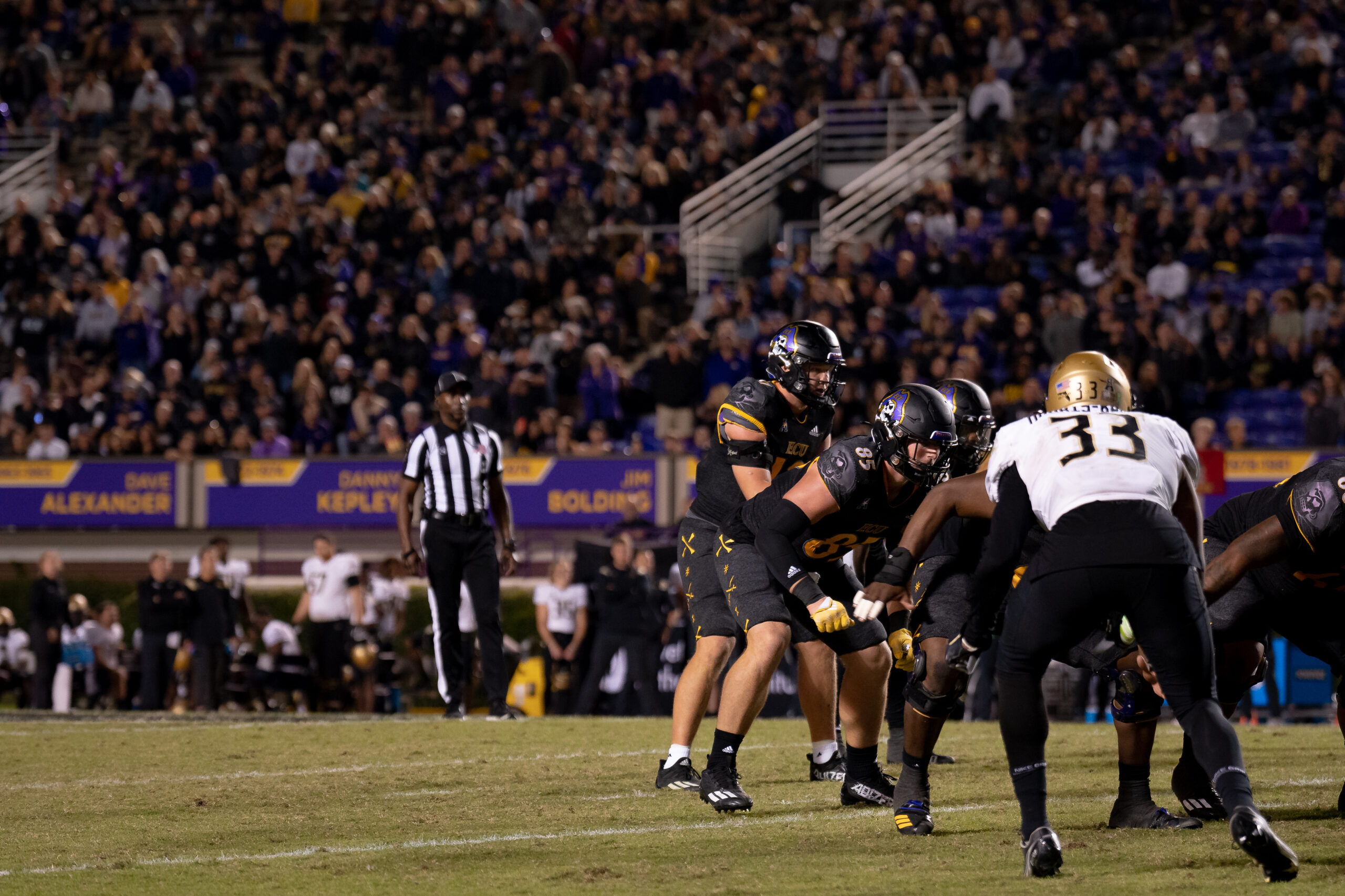 My First ECU College Football Photography Assignment 127 Players blocking at the line in front of the crowd