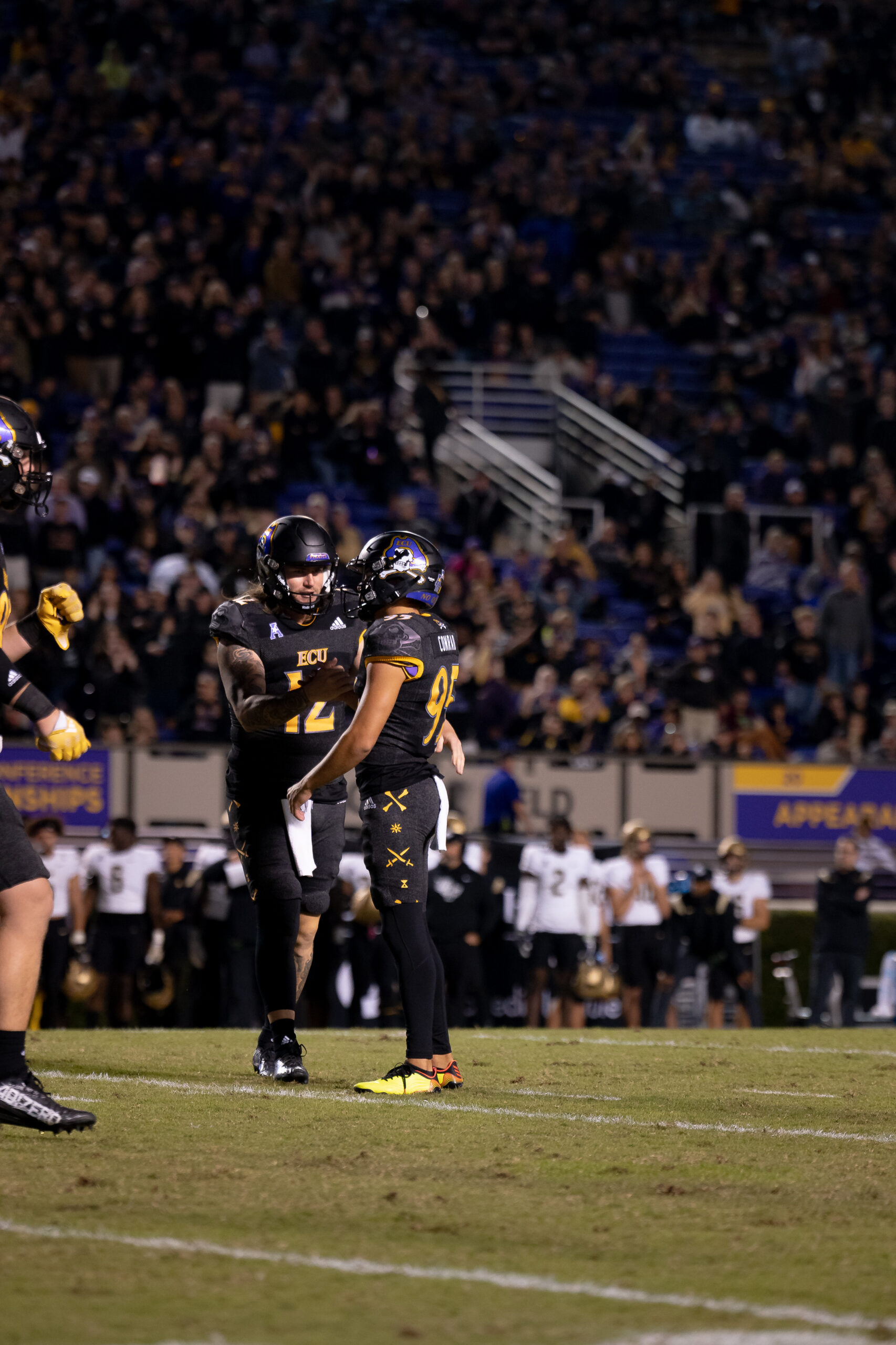 My First ECU College Football Photography Assignment 263 Vertical shot of an ECU player on the field with fans behind