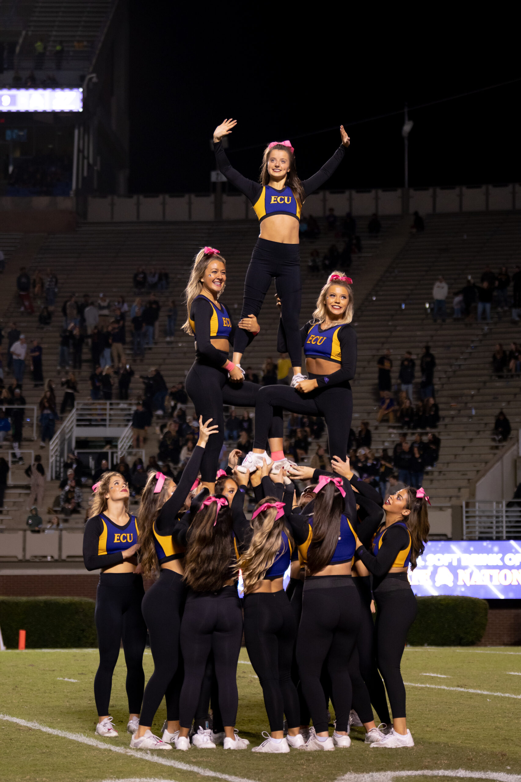 My First ECU College Football Photography Assignment 145 ECU cheerleaders forming a tall pyramid on the sideline