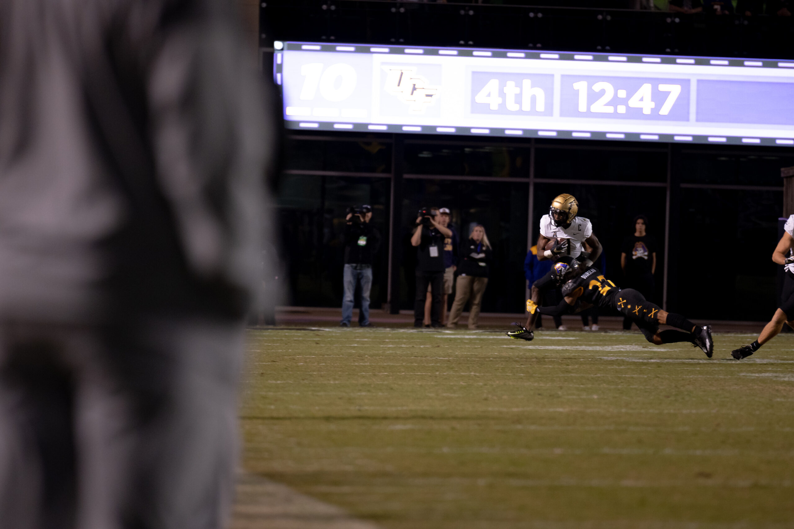 My First ECU College Football Photography Assignment 276 Player silhouetted in front of the stadium scoreboard