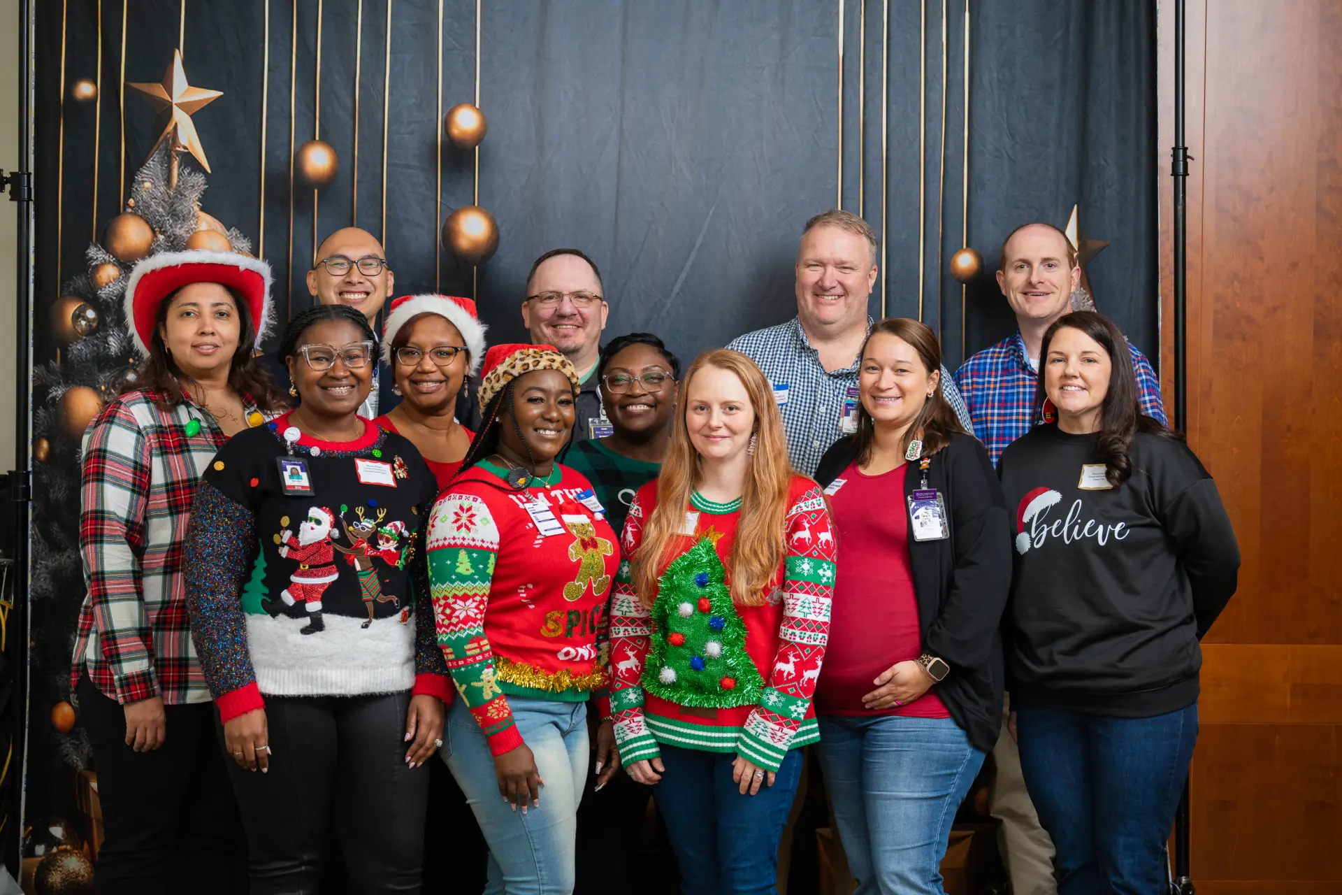 Staff in Santa hats and reindeer antlers posing together