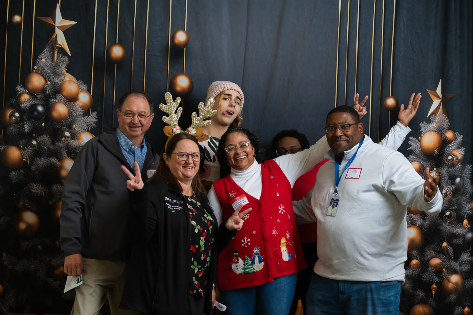 Coworkers in Santa hats celebrating at the holiday party