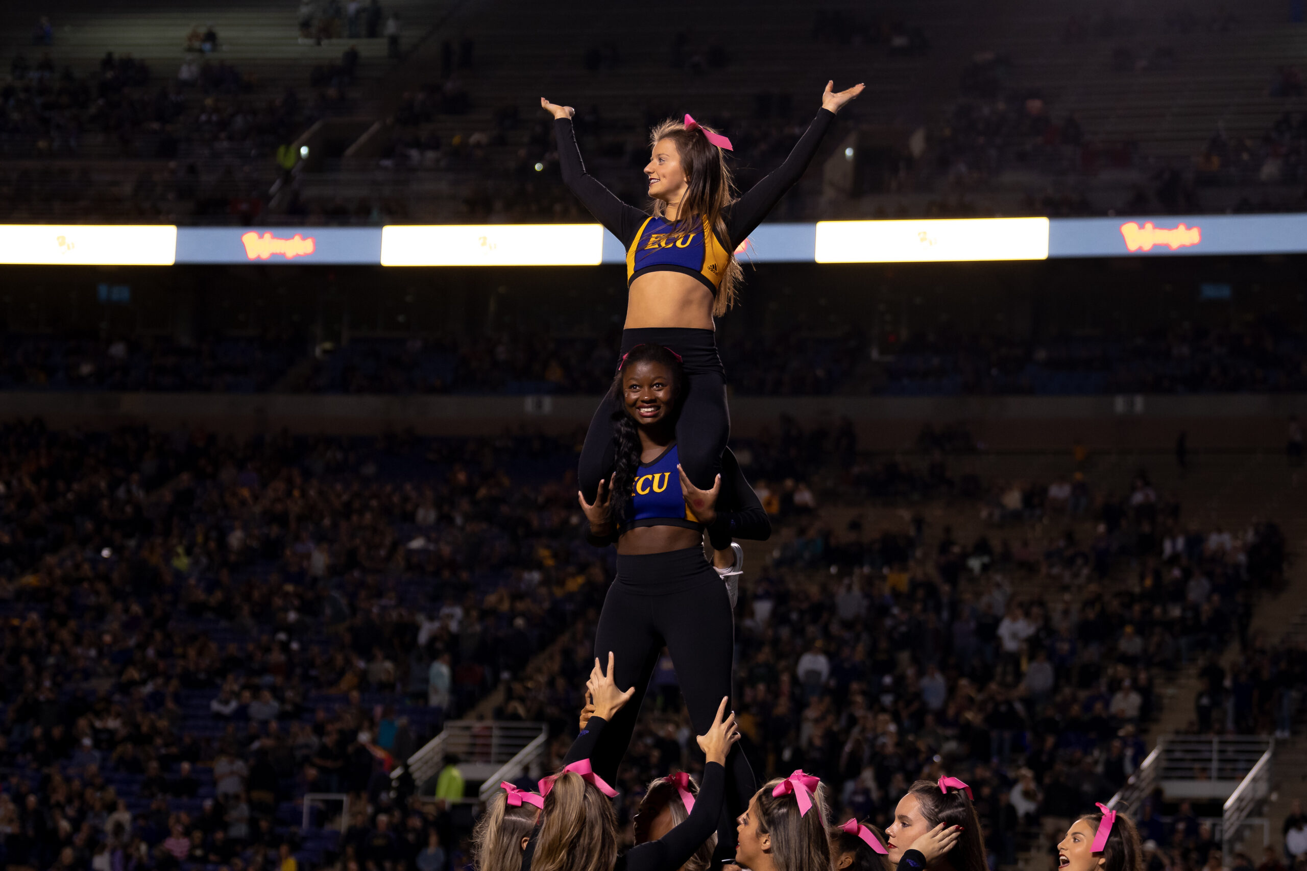 My First ECU College Football Photography Assignment 45 ECU cheerleader lifted high above the sideline
