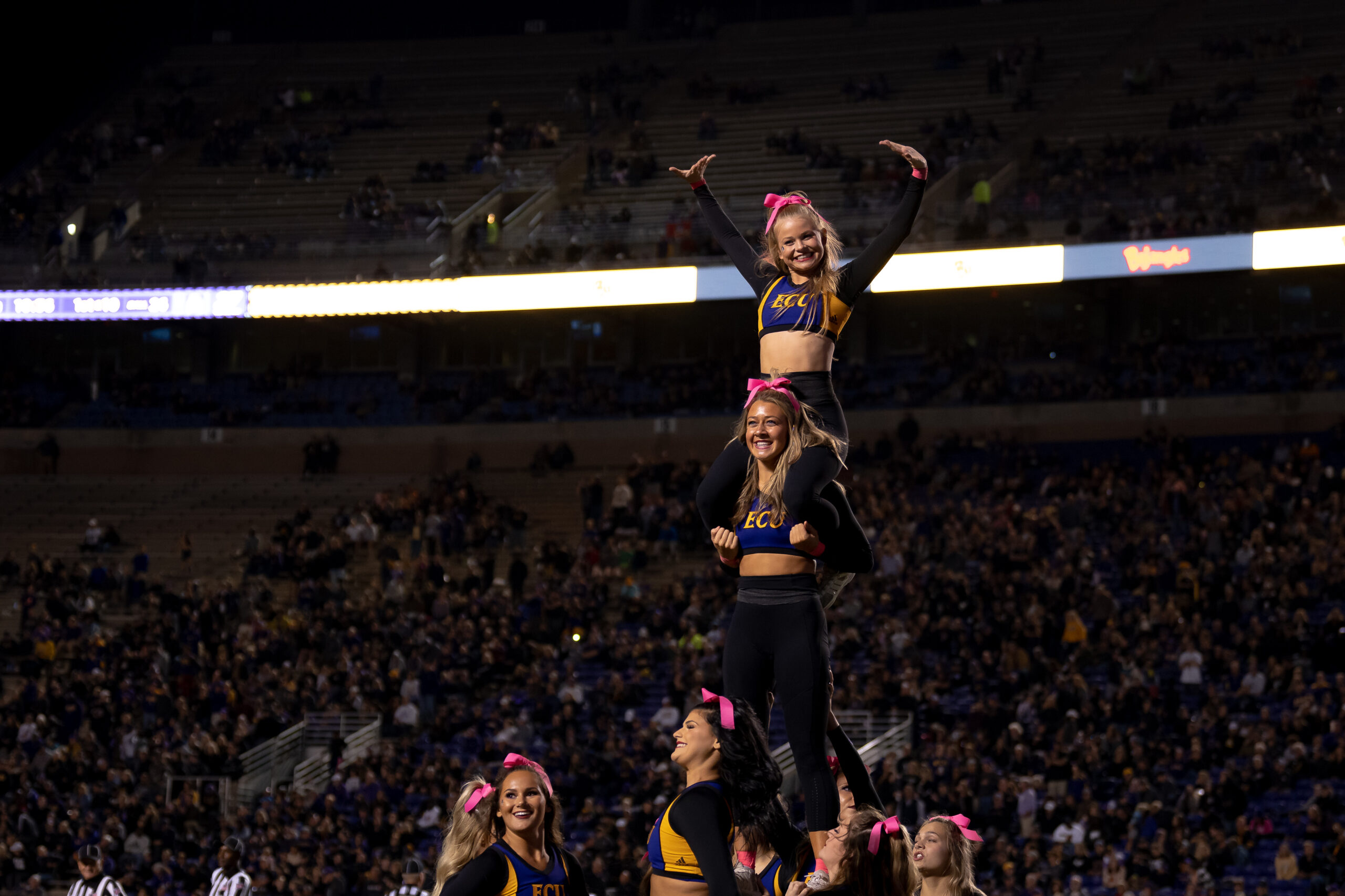 My First ECU College Football Photography Assignment 269 ECU cheerleader held aloft against the night sky
