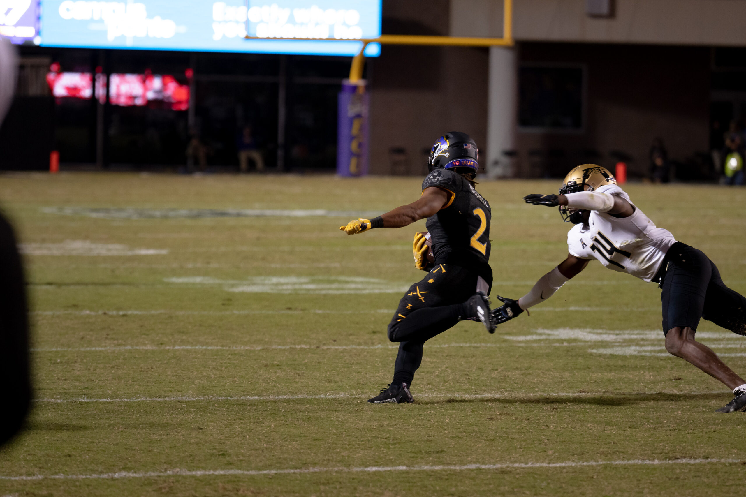 My First ECU College Football Photography Assignment 91 UCF player diving to make a tackle on an ECU runner