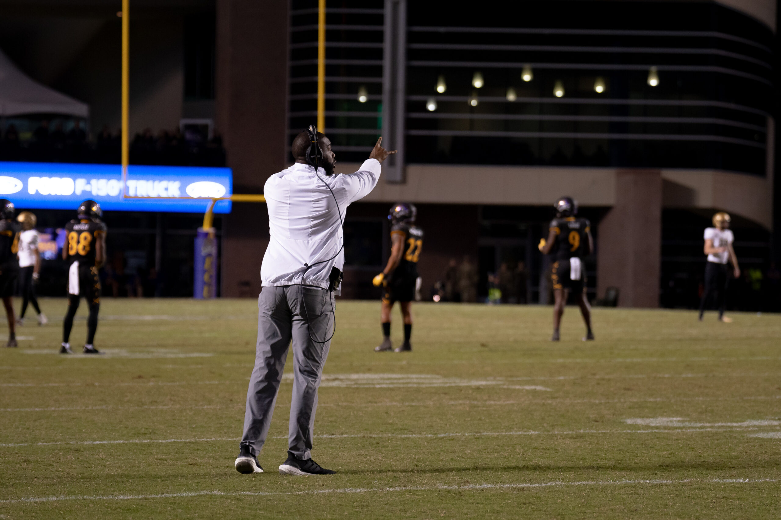 My First ECU College Football Photography Assignment 216 Staff member signaling to the sideline