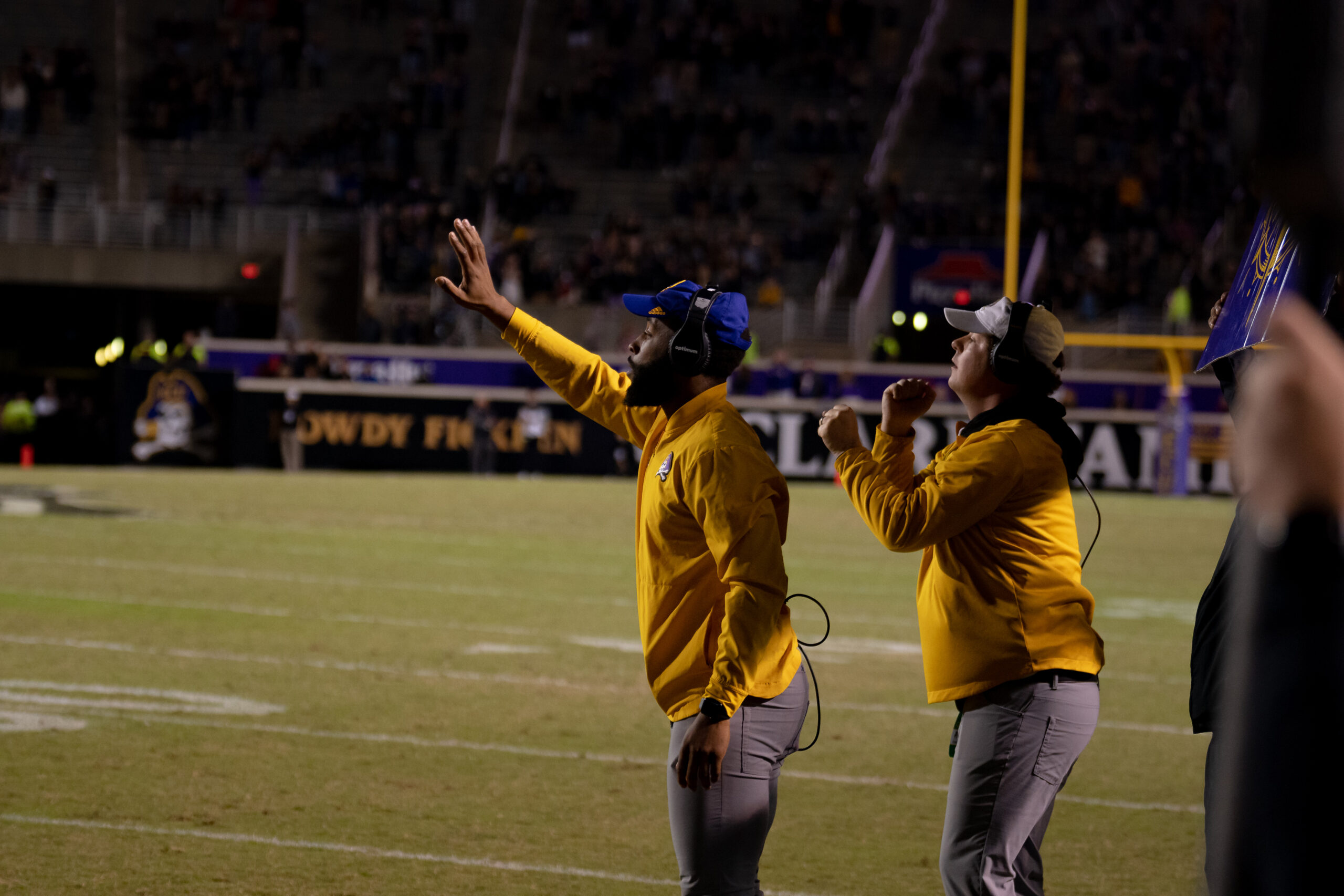 My First ECU College Football Photography Assignment 110 ECU staff in yellow signaling from the sideline