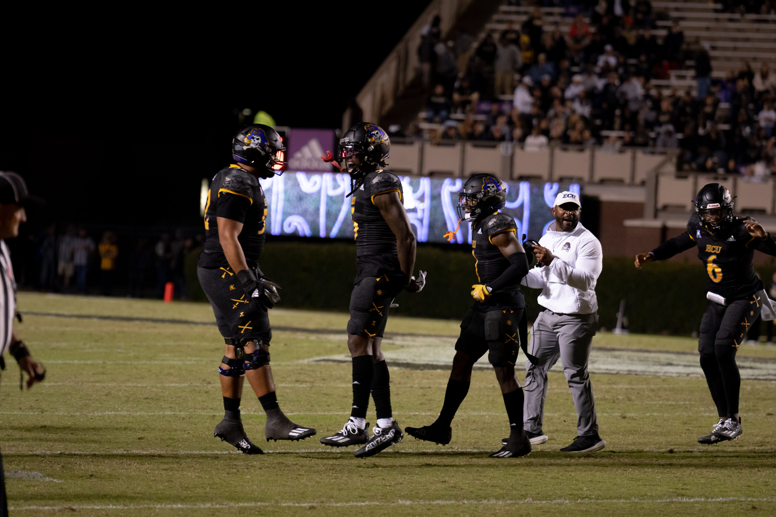 My First ECU College Football Photography Assignment 100 ECU players jogging along the sideline at night