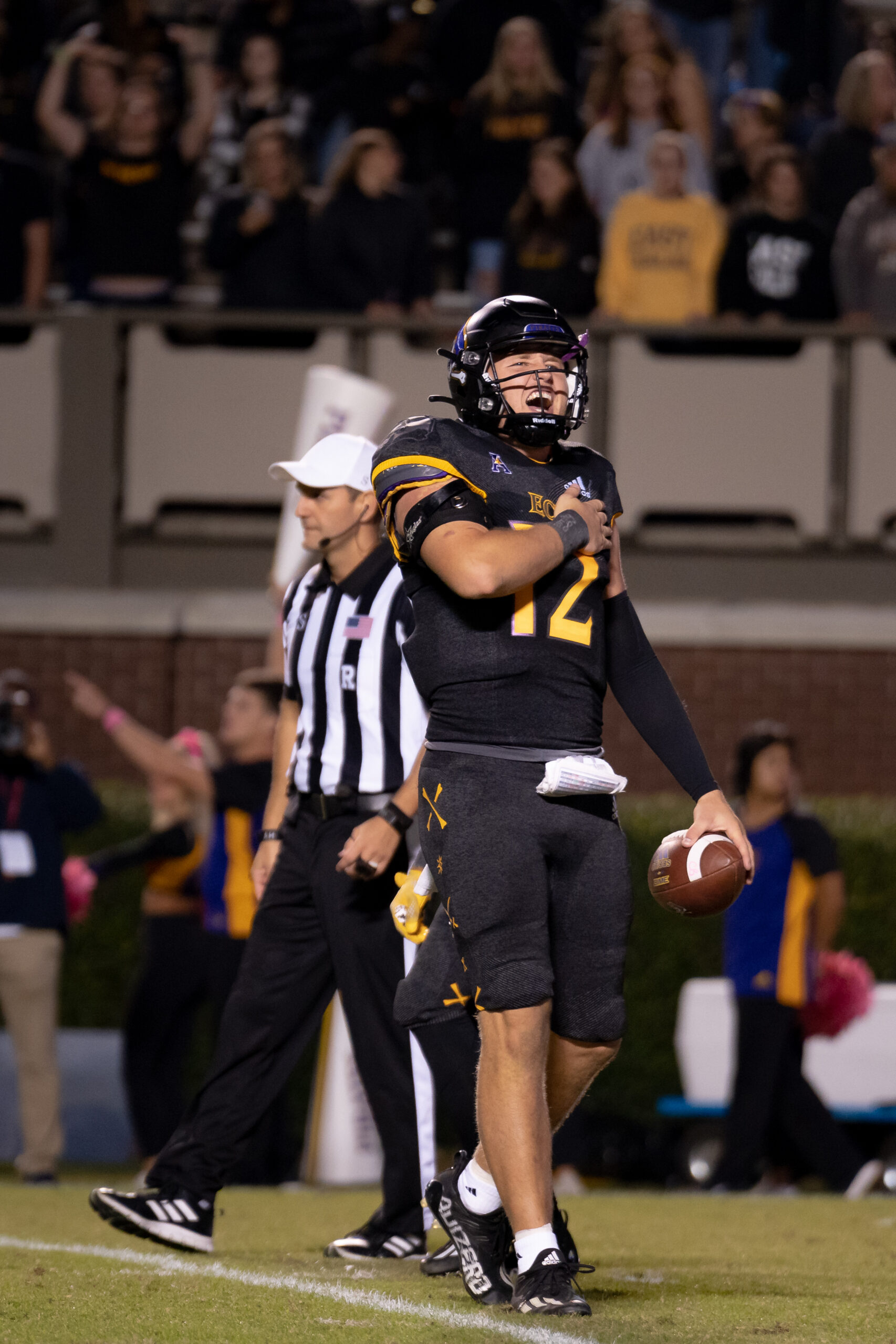 My First ECU College Football Photography Assignment 40 Referee standing beside an ECU player on the sideline