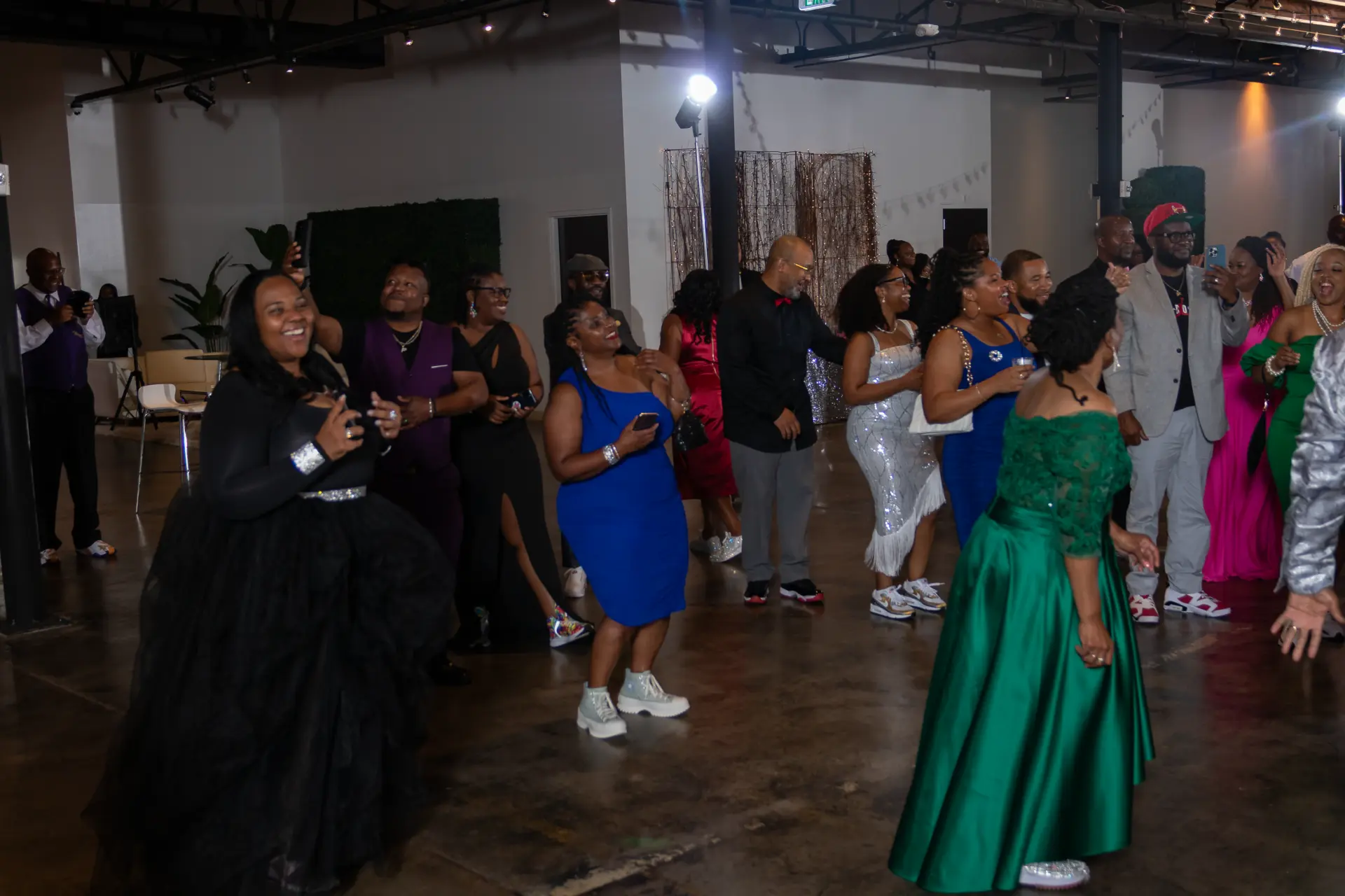 Party guests dancing in a dimly lit hall