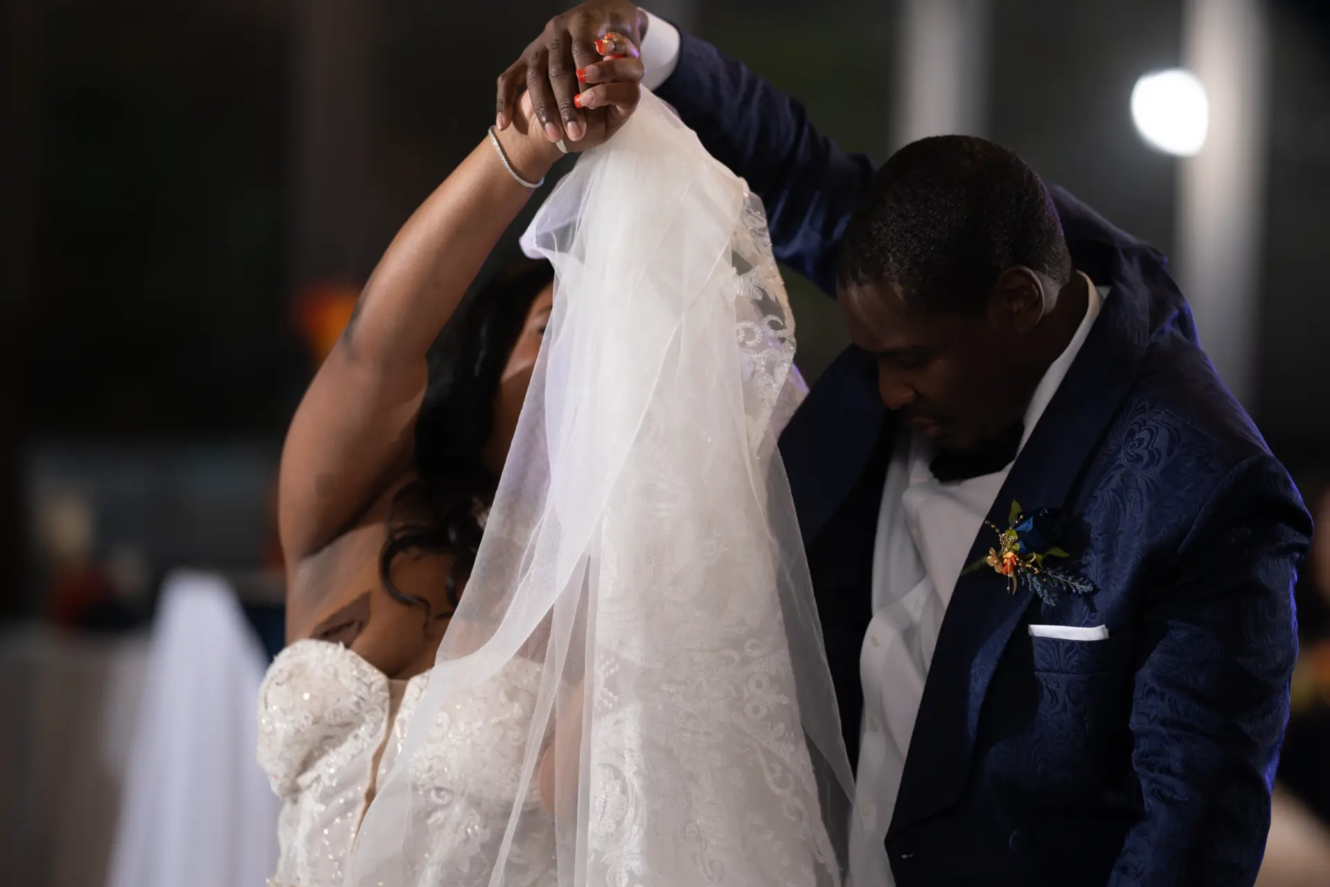 Groom lifts the bride's veil during the ceremony