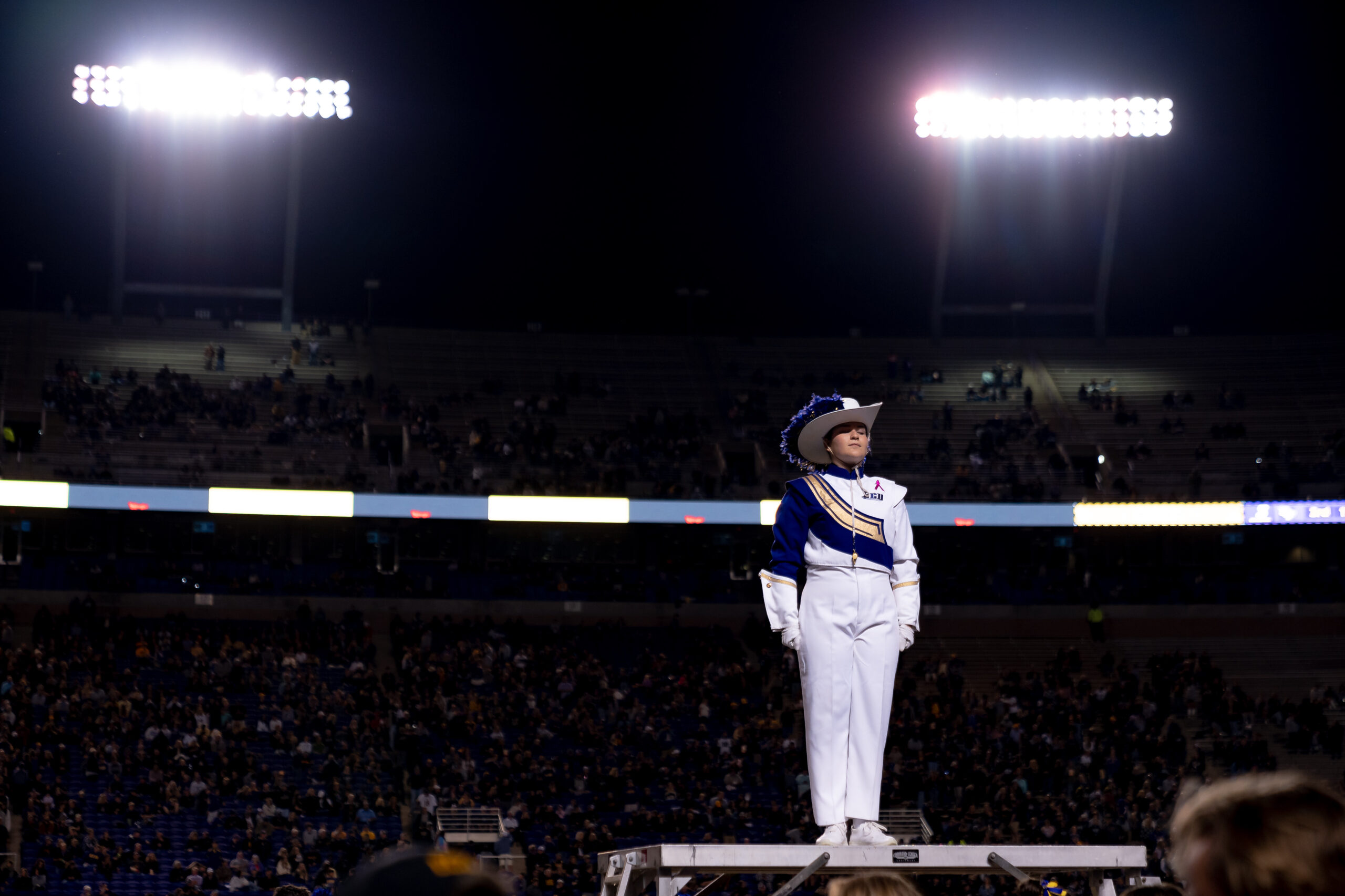 My First ECU College Football Photography Assignment 207 Drum major standing atop a podium under the stadium lights