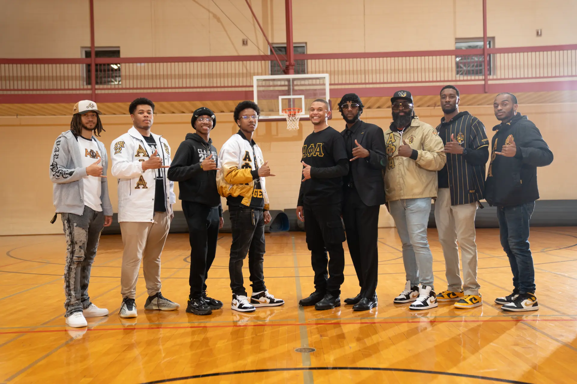 Group of guests posing in a gymnasium at an event
