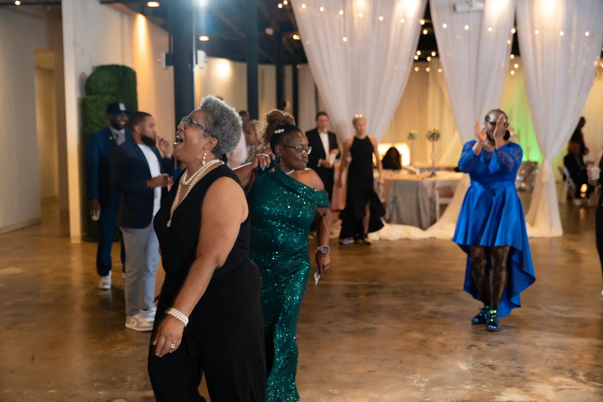 Guests mingling on the dance floor at an evening reception