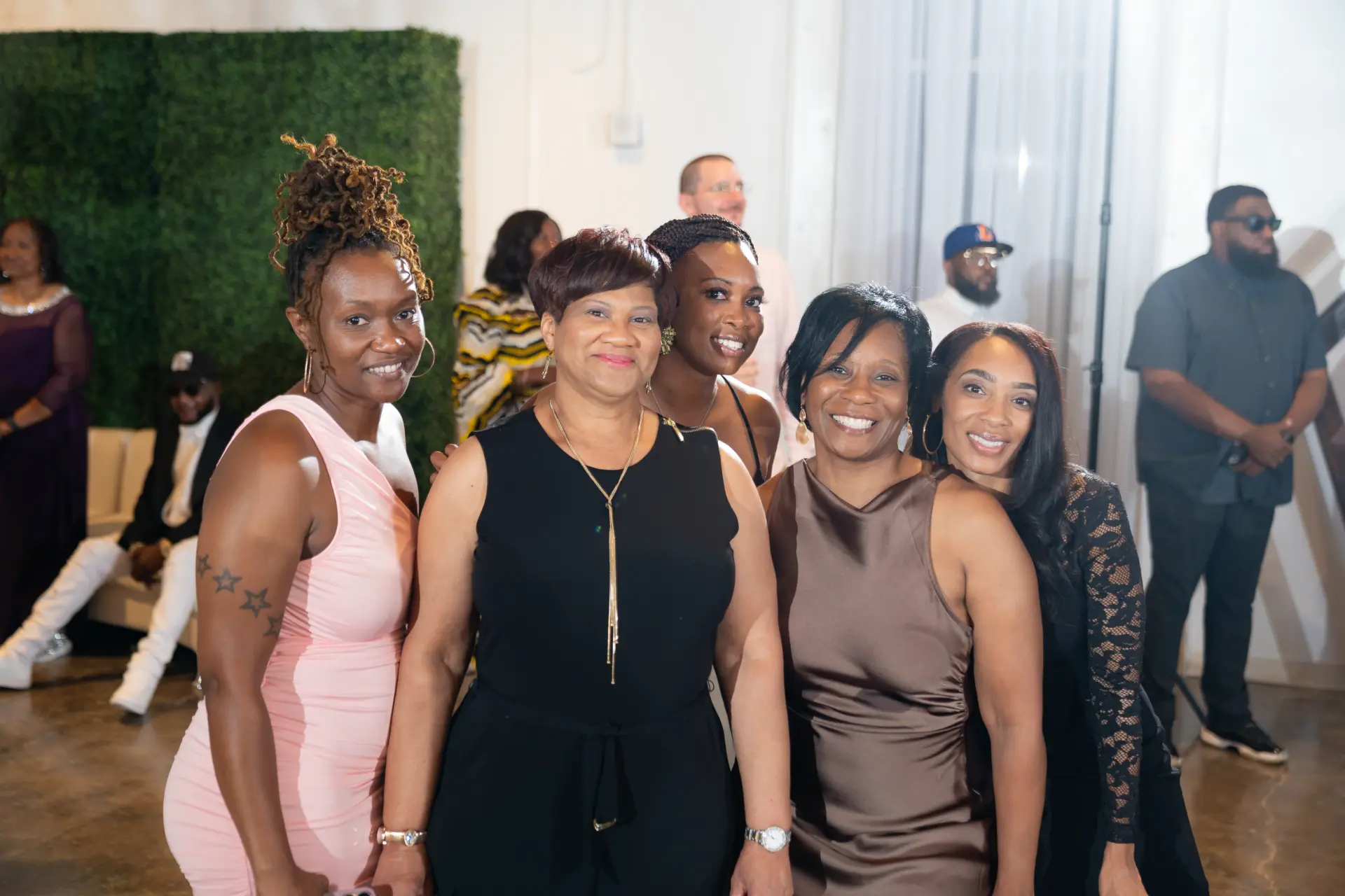 Group of women in elegant dresses posing at a celebration