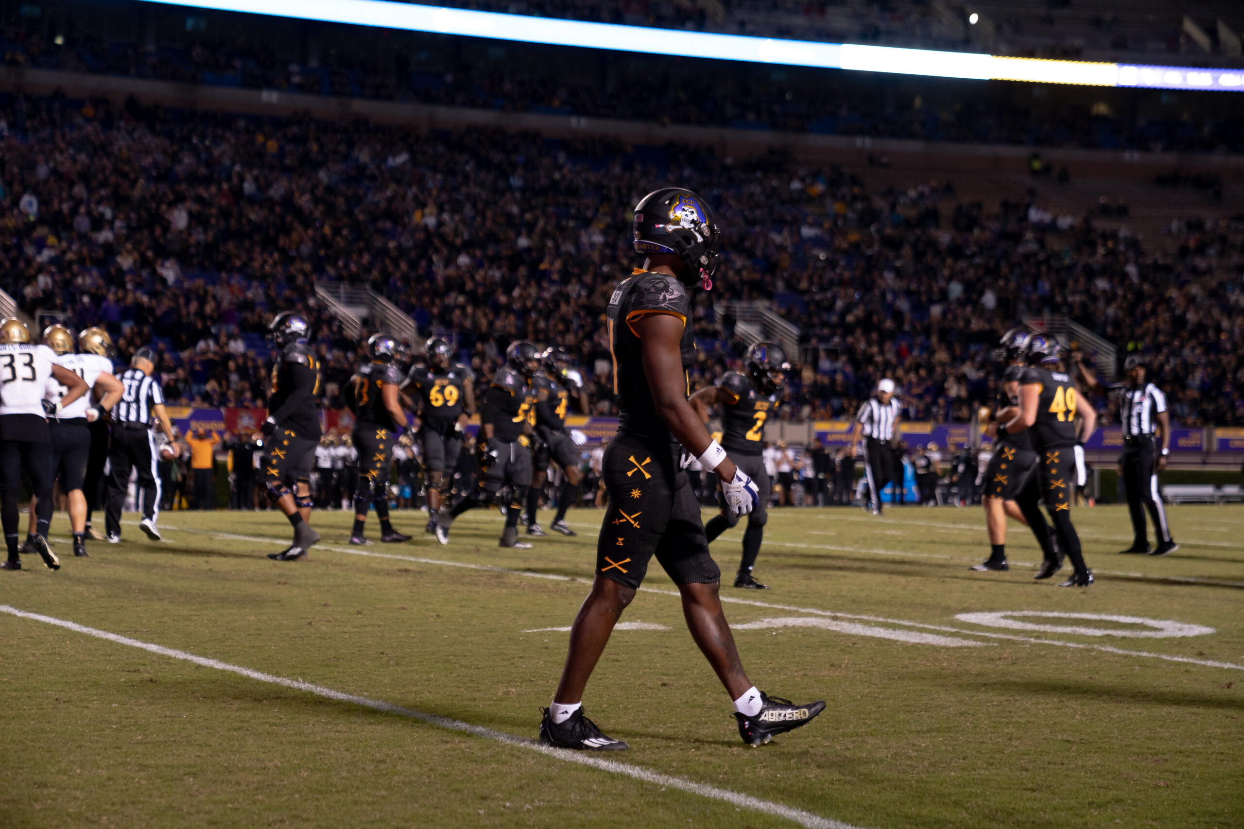 My First ECU College Football Photography Assignment 31 ECU player jogging across the field at night