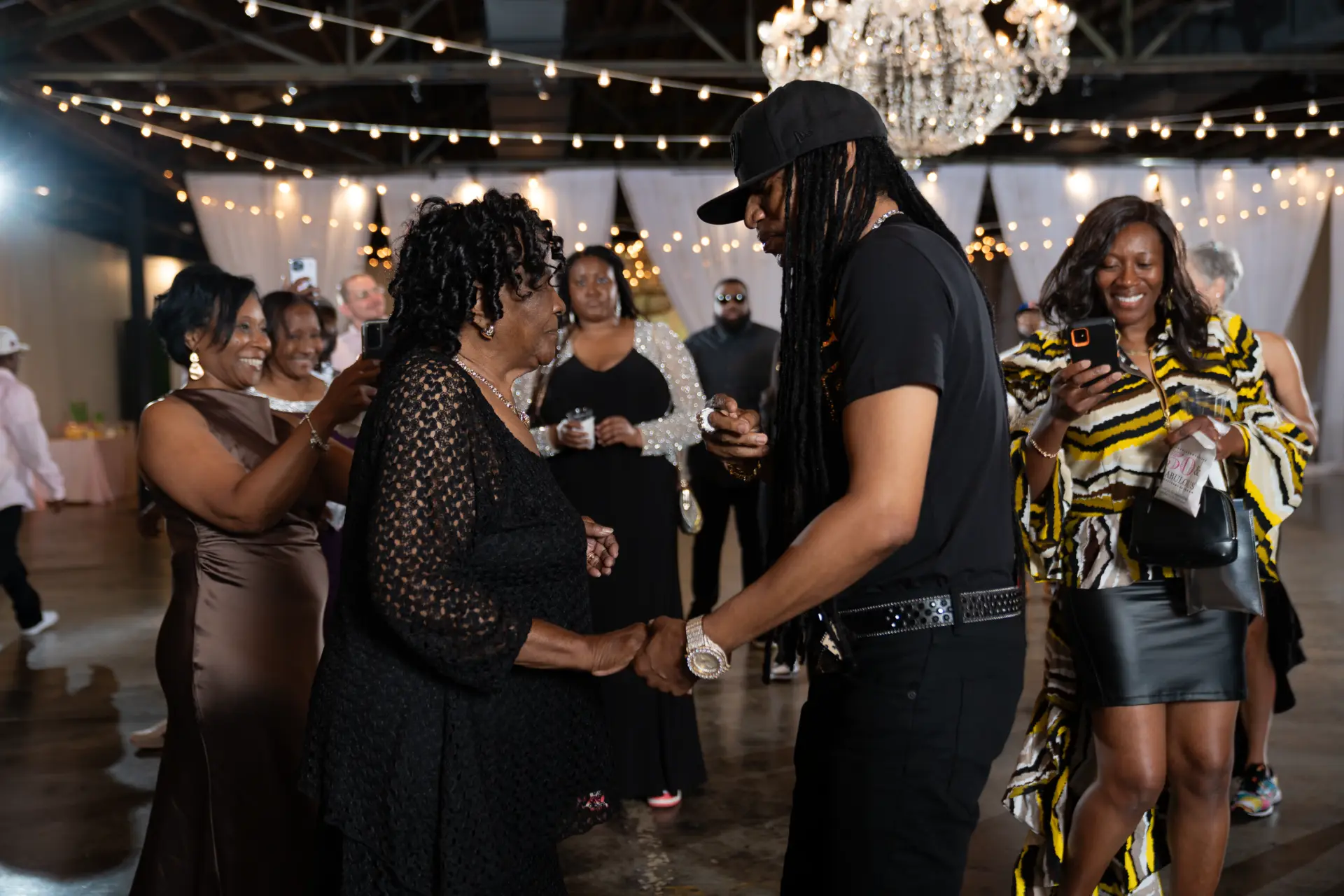 Guests dancing and laughing at a crowded party
