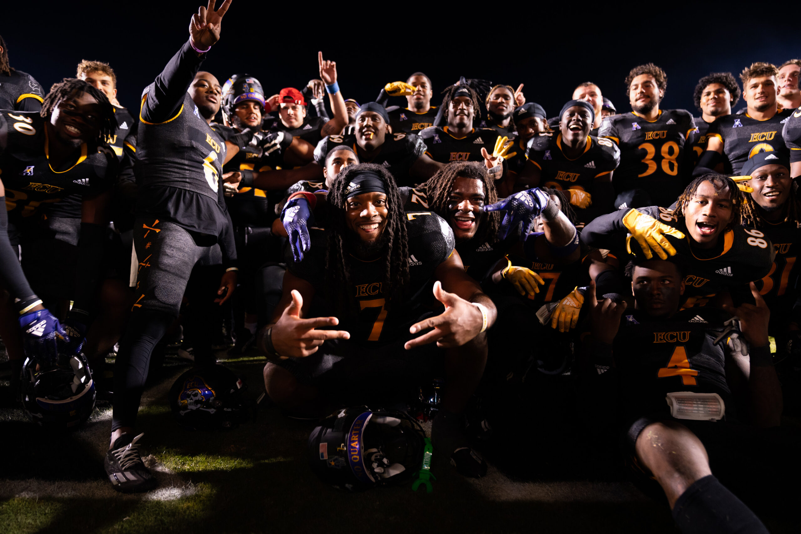 My First ECU College Football Photography Assignment 60 ECU players celebrating in a tight group on the sideline