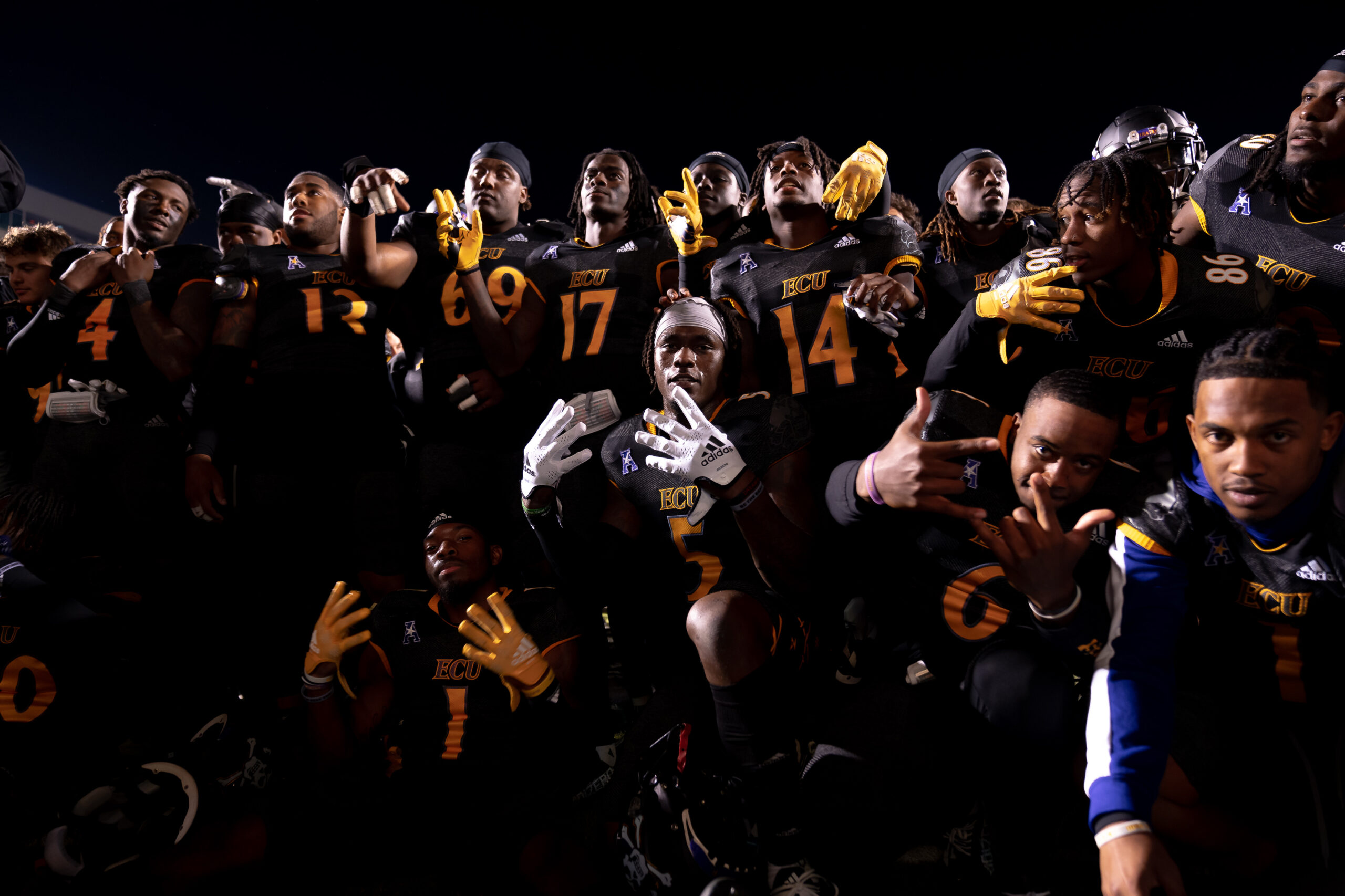 My First ECU College Football Photography Assignment 278 ECU players celebrating together in a dark huddle