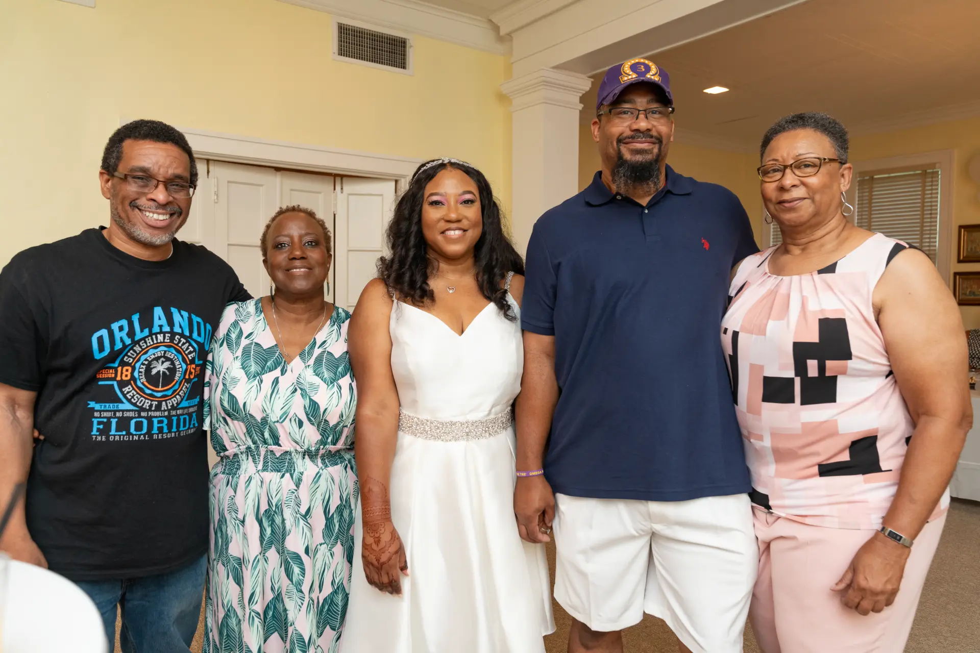 Family lined up for a group photo in a bright living room