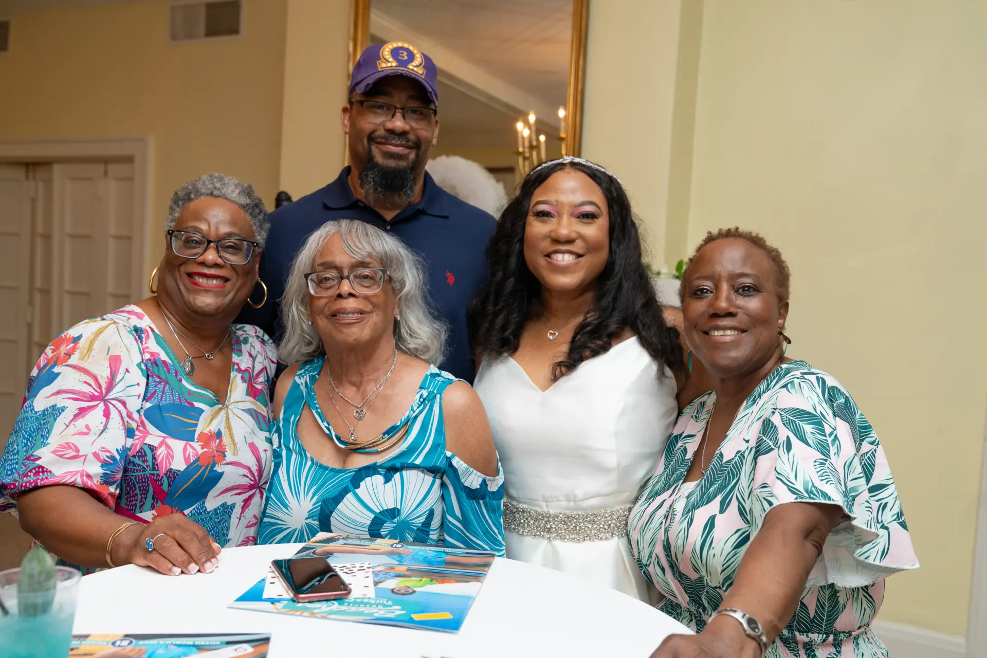 Family members seated around a table at a house party